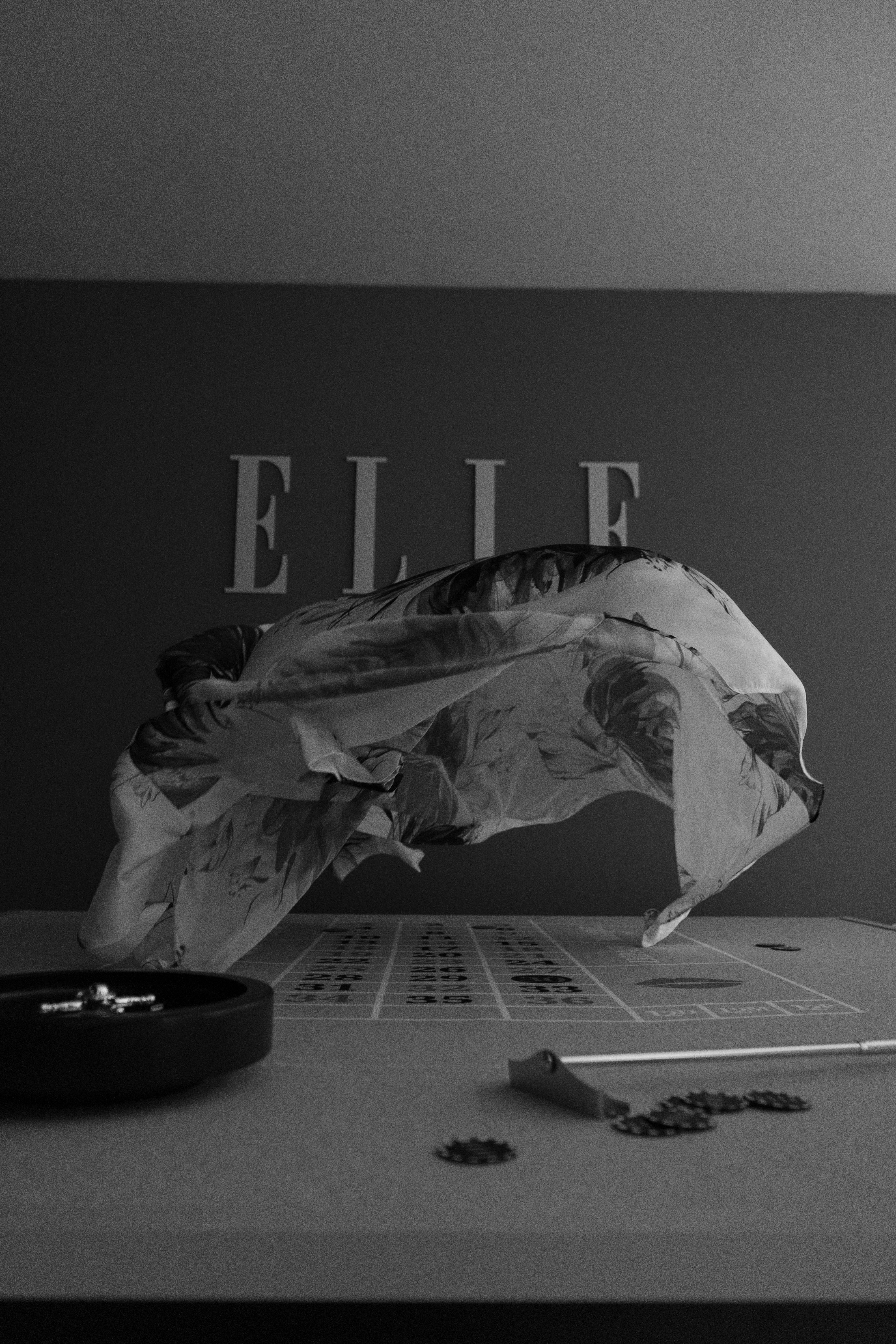 A black and white photo of a table with a bag on top of it