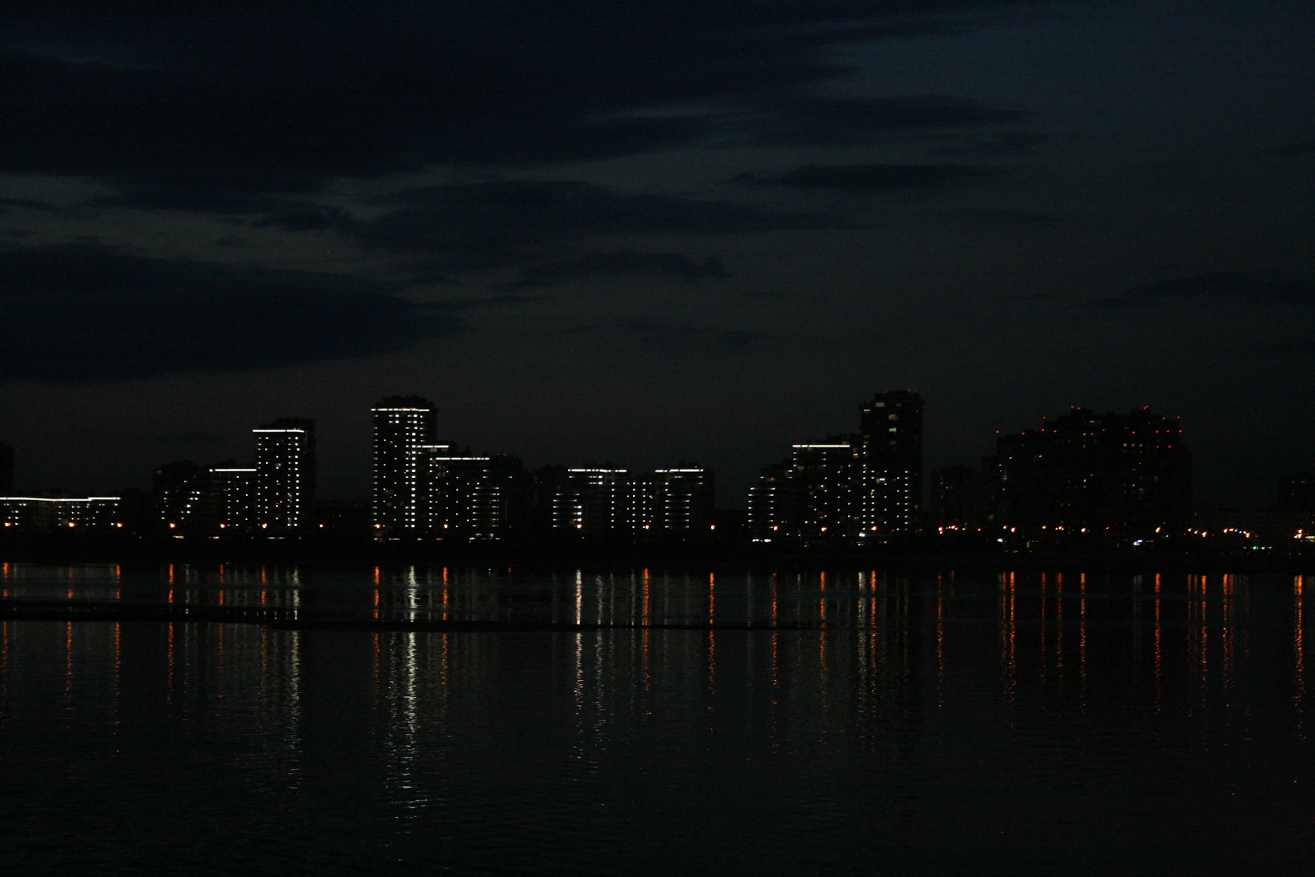 A city skyline is lit up at night