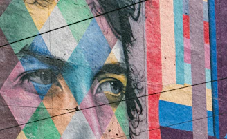 A close up of a person's face painted on a wall