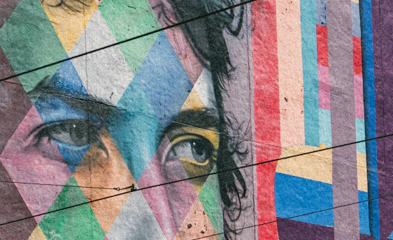 A close up of a person's face painted on a wall