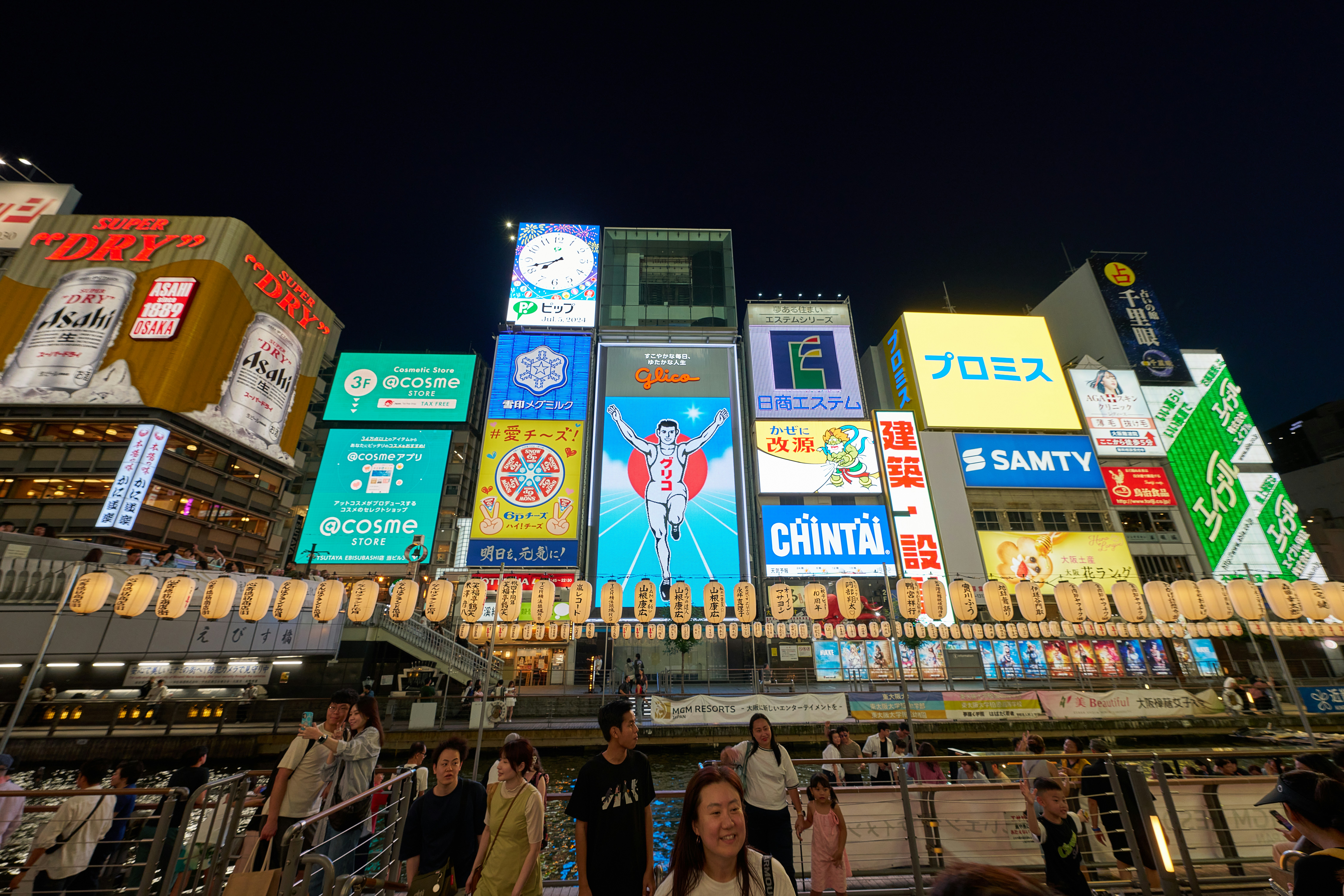 A group of people standing in front of a tall building