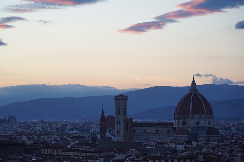 Florence cityscape panorama with the Duomo and distant mountains at sunset
