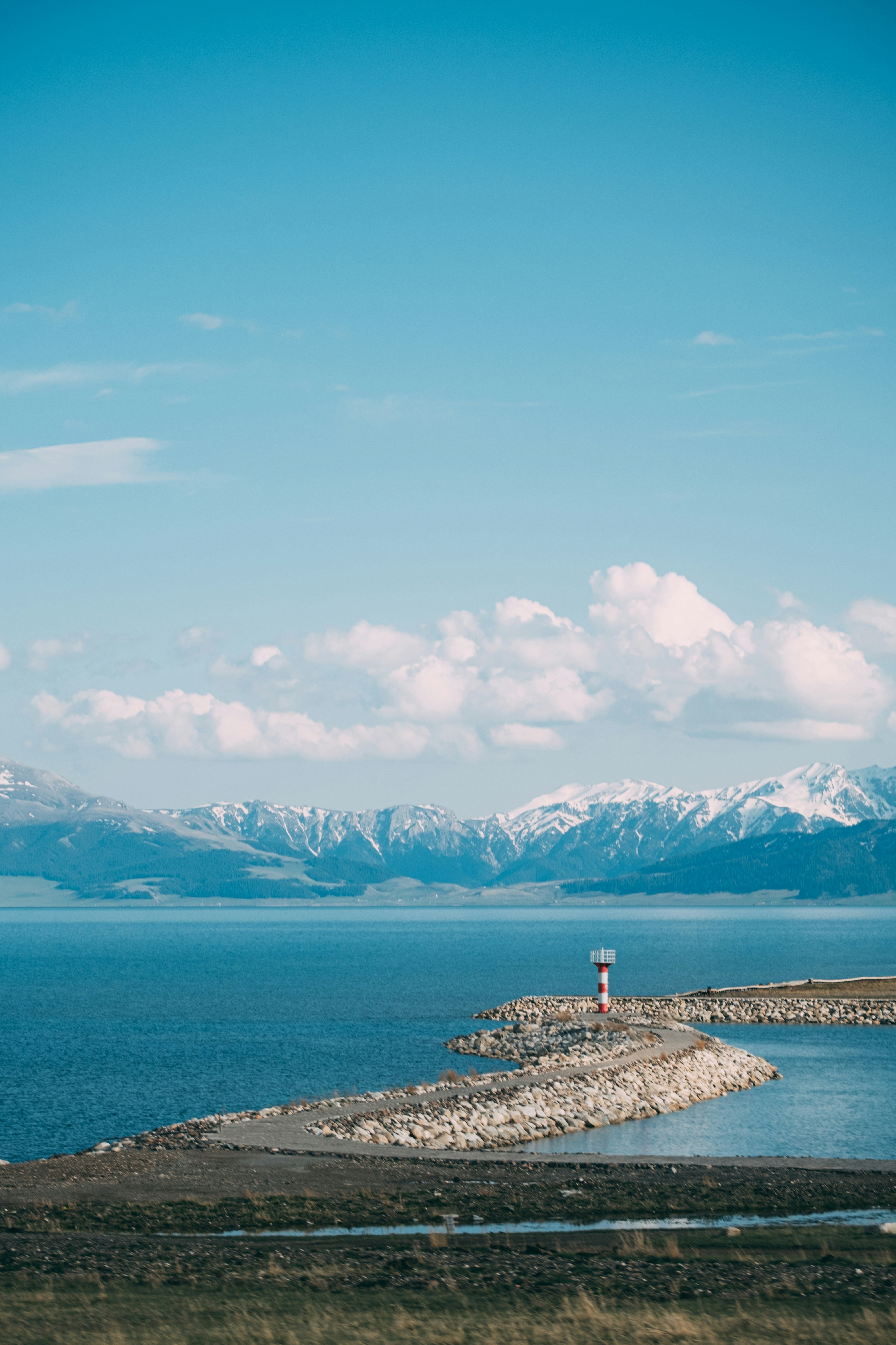 A body of water with mountains in the background