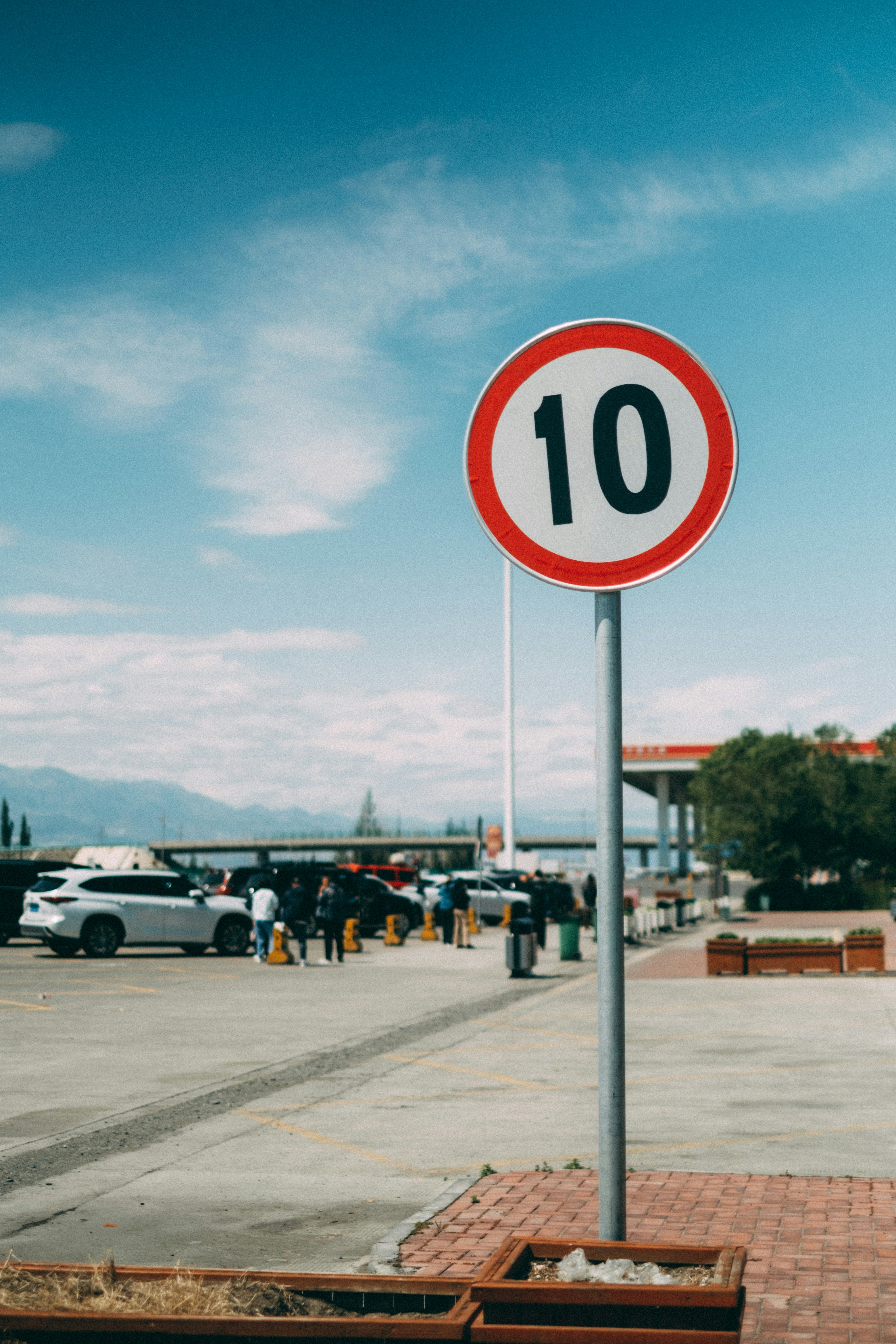 A red and white street sign sitting on the side of a road