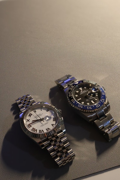A couple of watches sitting on top of a table