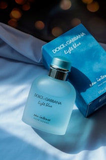 A bottle of dolce garbana light blue next to a box