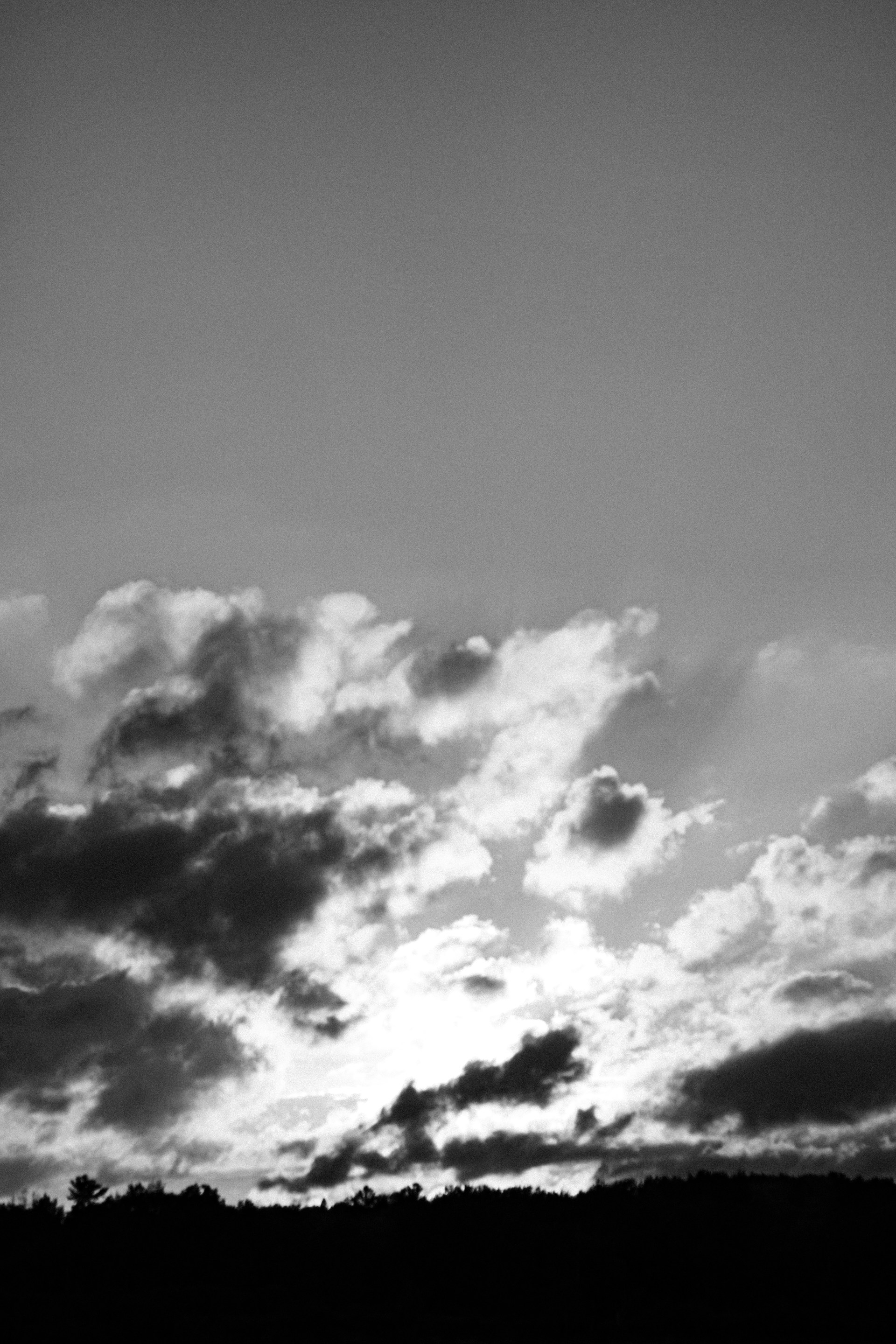 A black and white photo of a sky with clouds