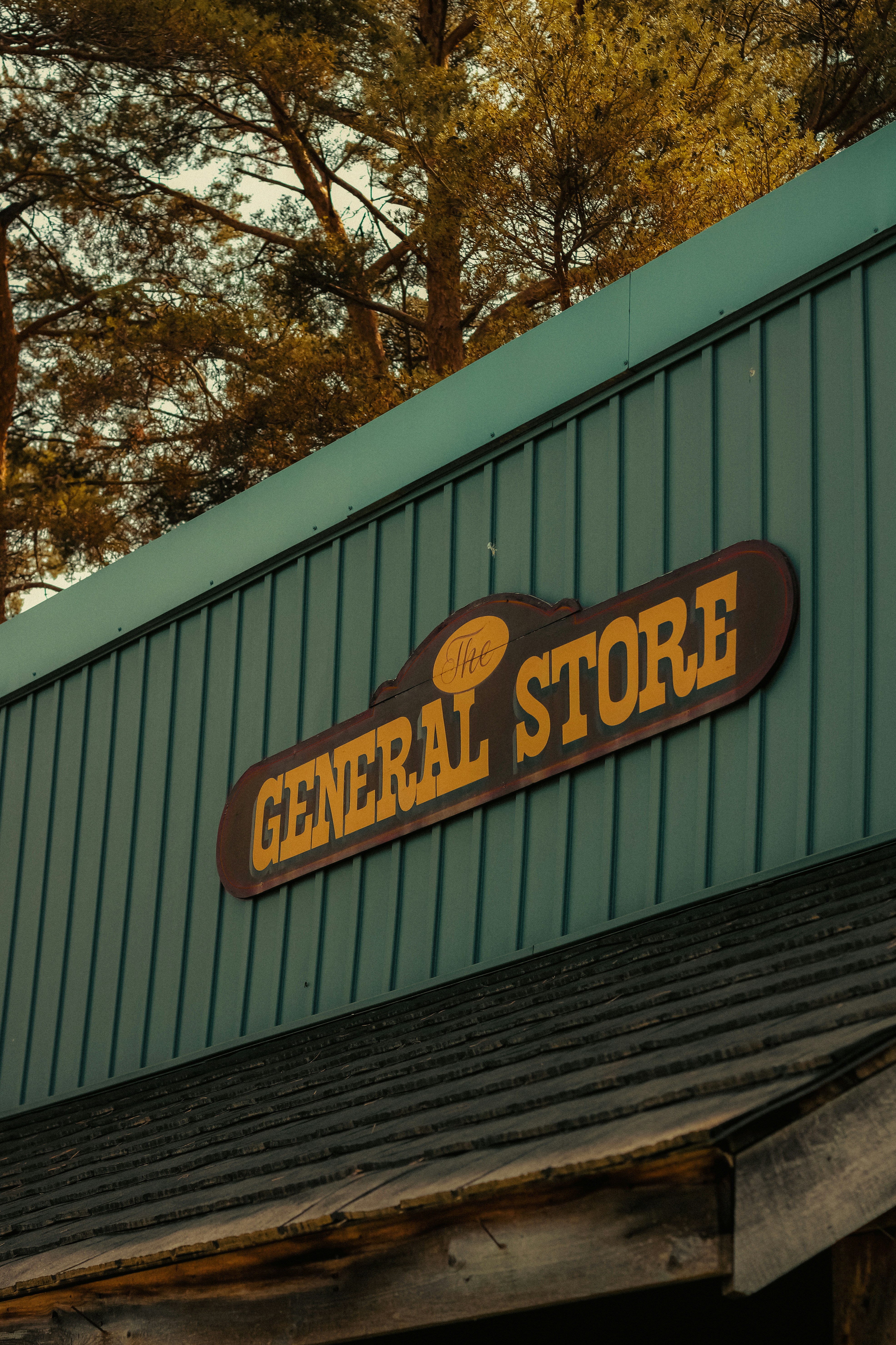A store sign on the side of a building photo – Free Building Image on ...