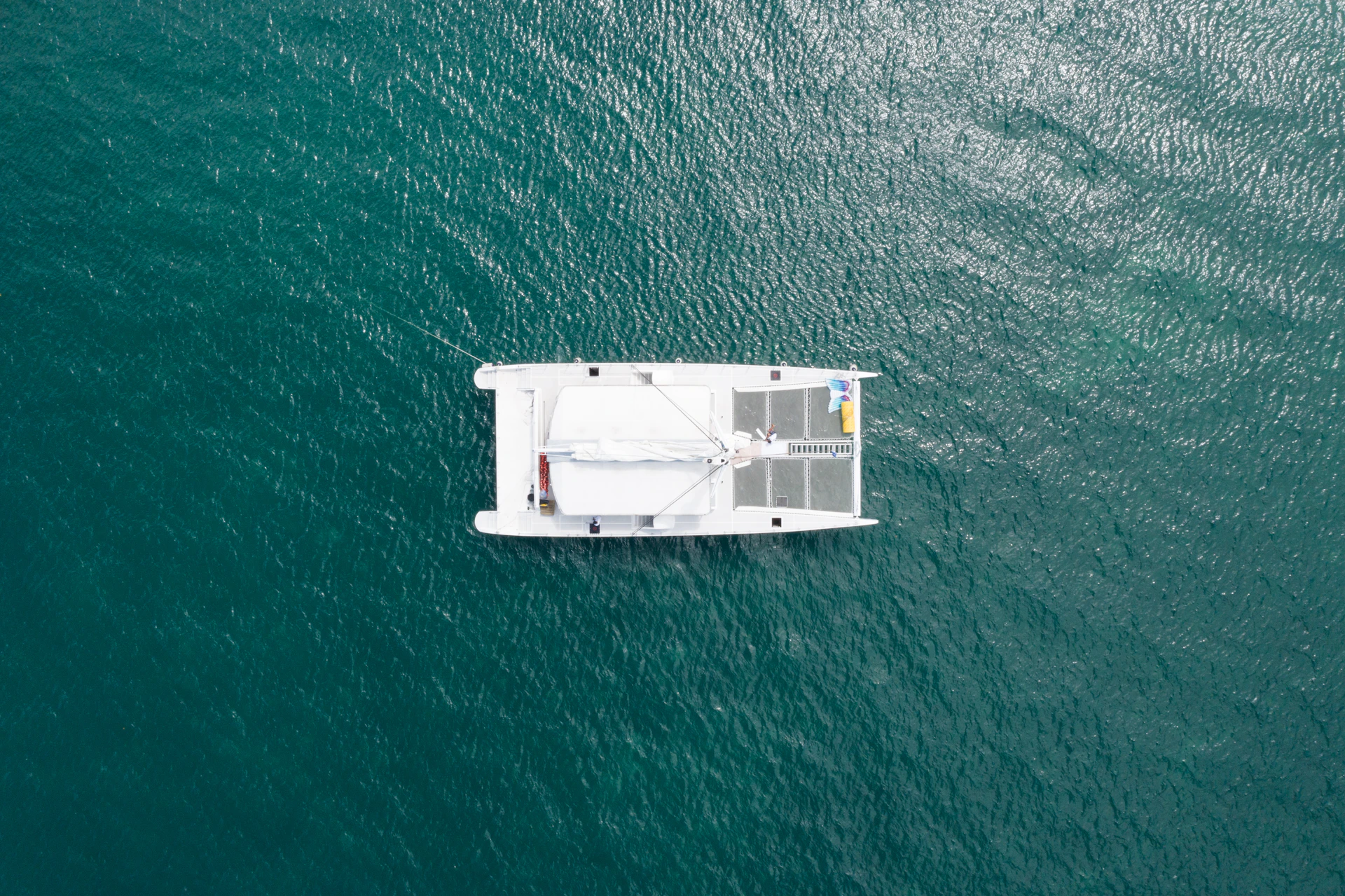 A white boat floating on top of a large body of water