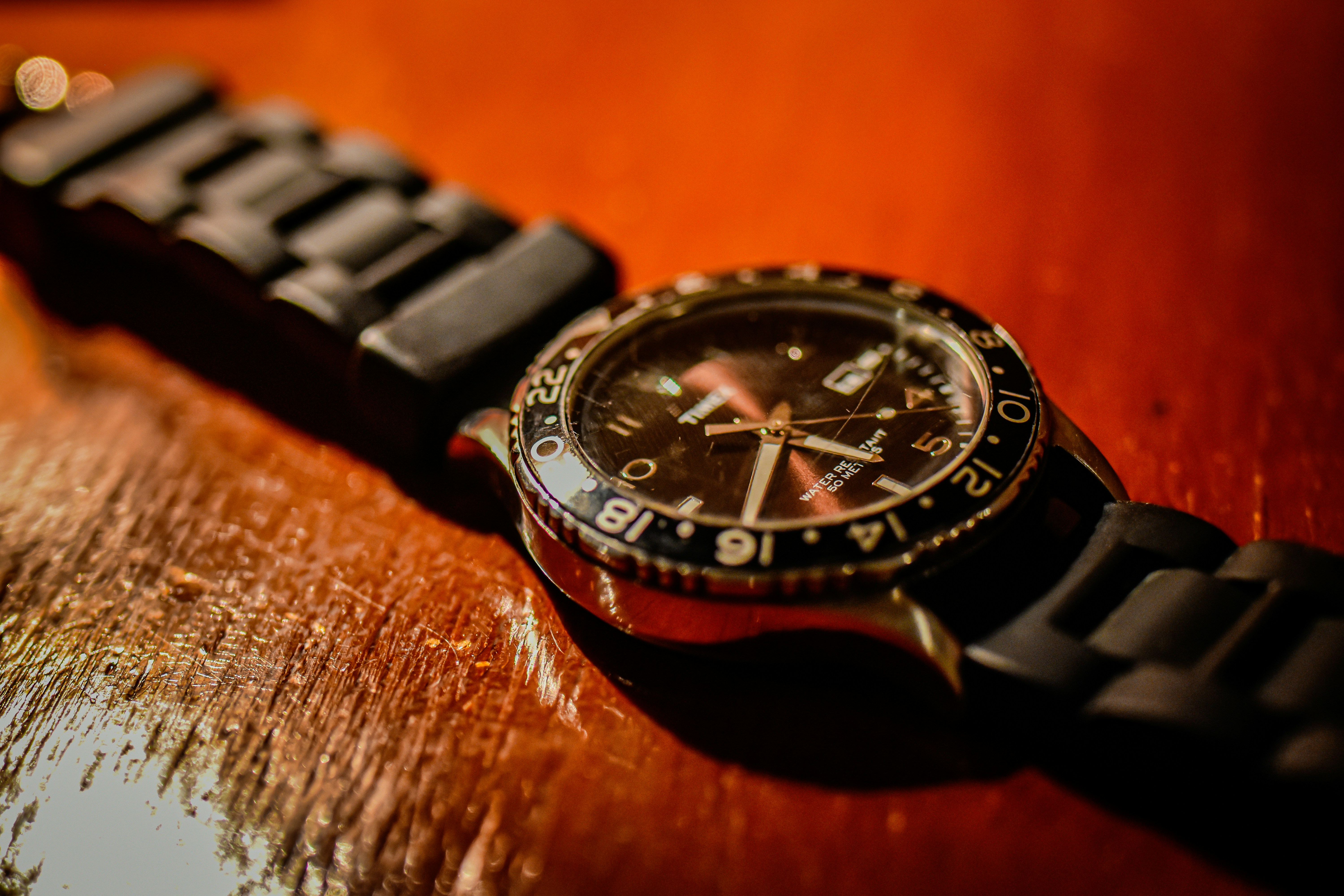 A watch sitting on top of a wooden table