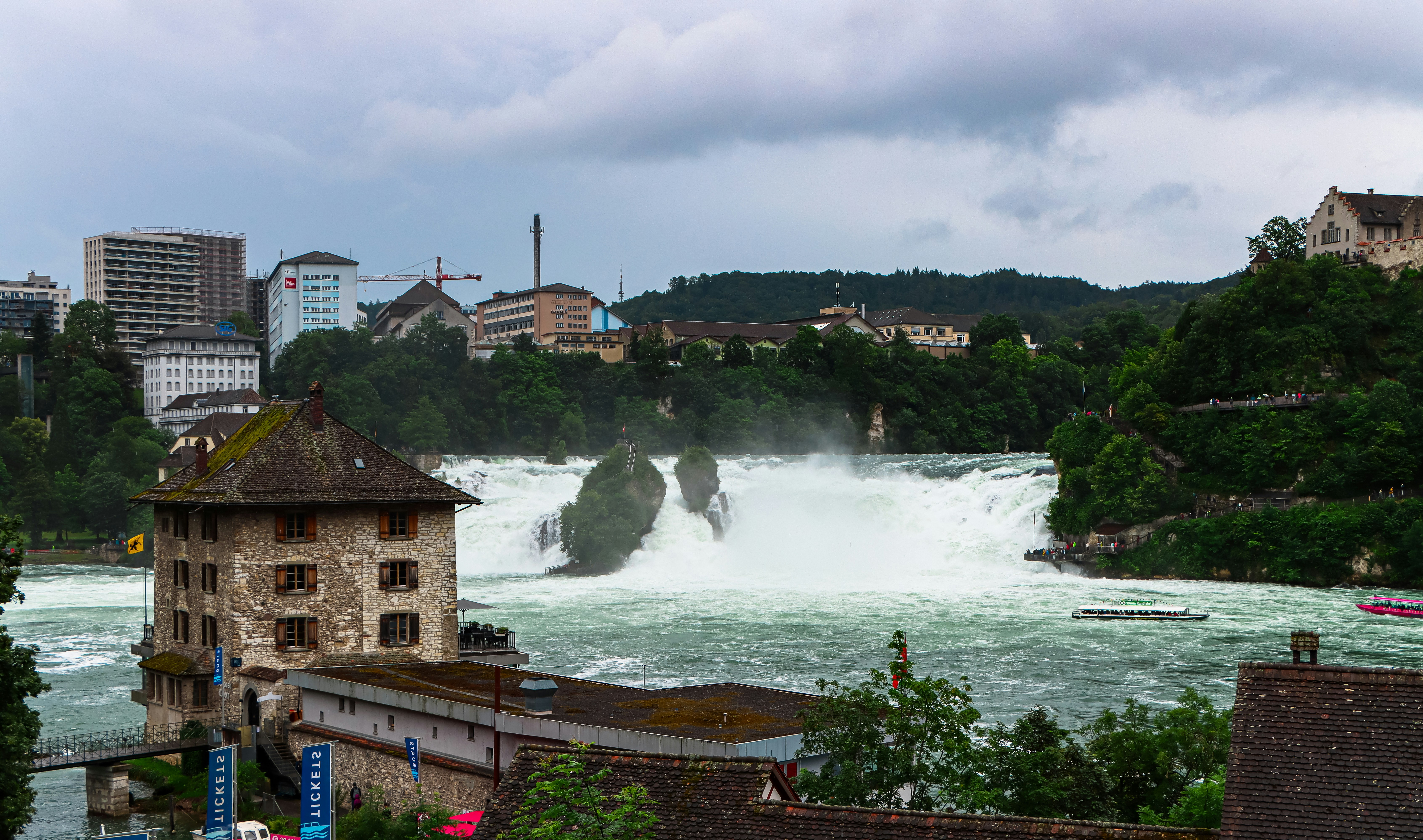 A view of a river with a waterfall in the background