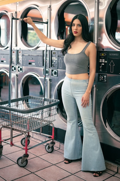 A woman standing in front of a stack of washers