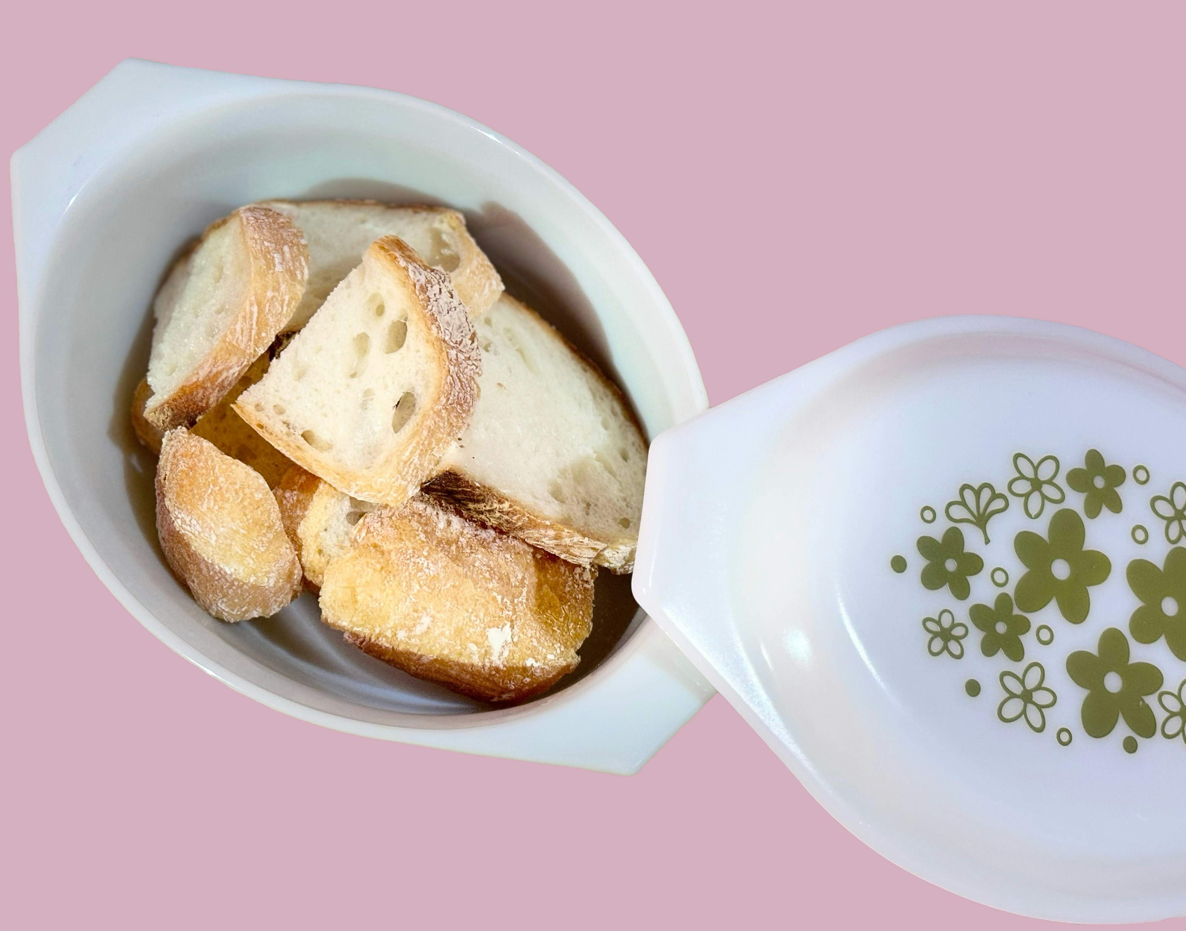 A white bowl filled with food on top of a pink table