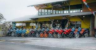 A row of motorcycles parked in front of a building