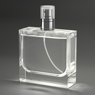 A clear glass bottle with a silver top