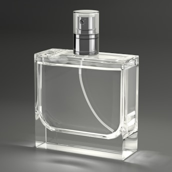 A clear glass bottle with a silver top