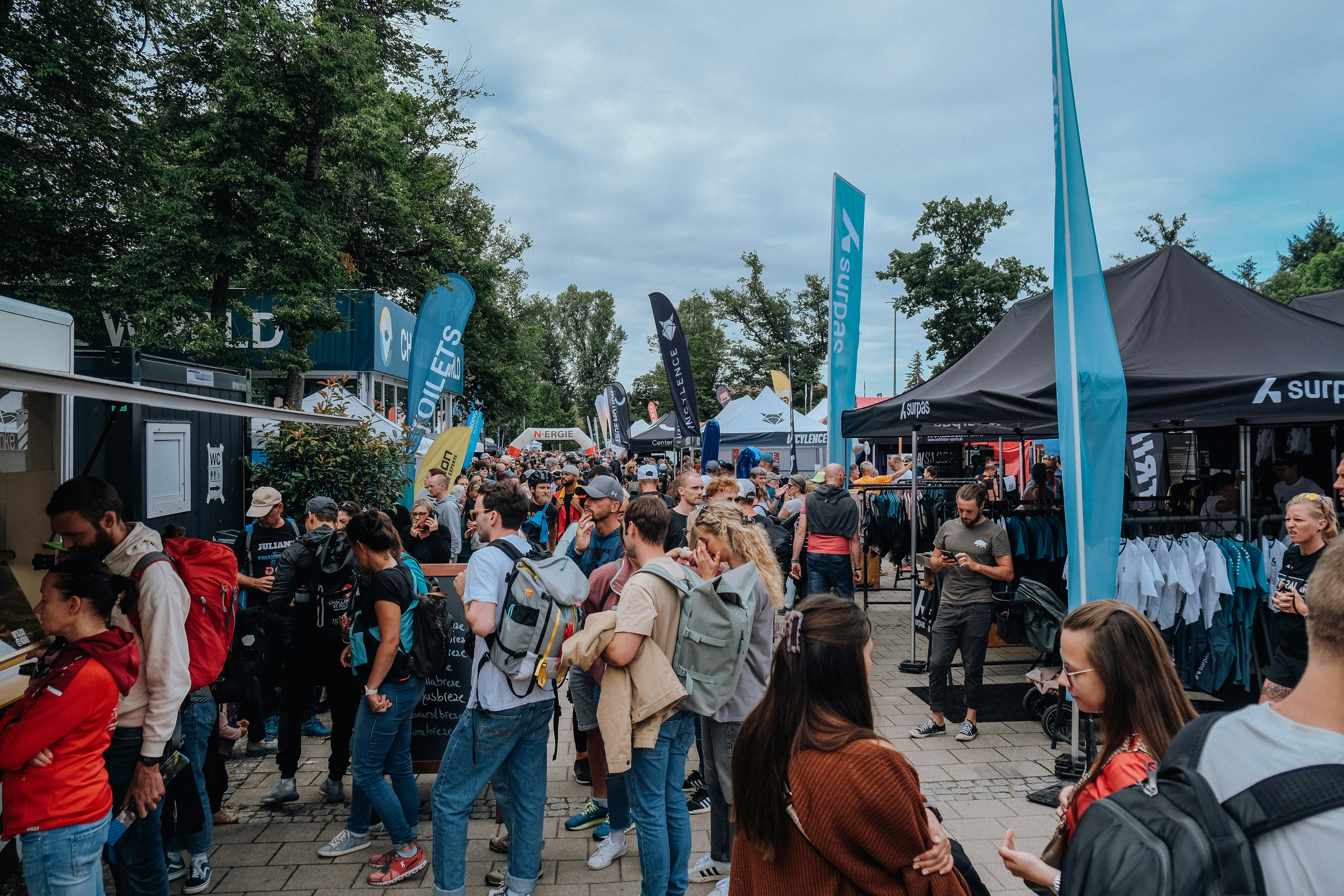 A crowd of people standing around a tent