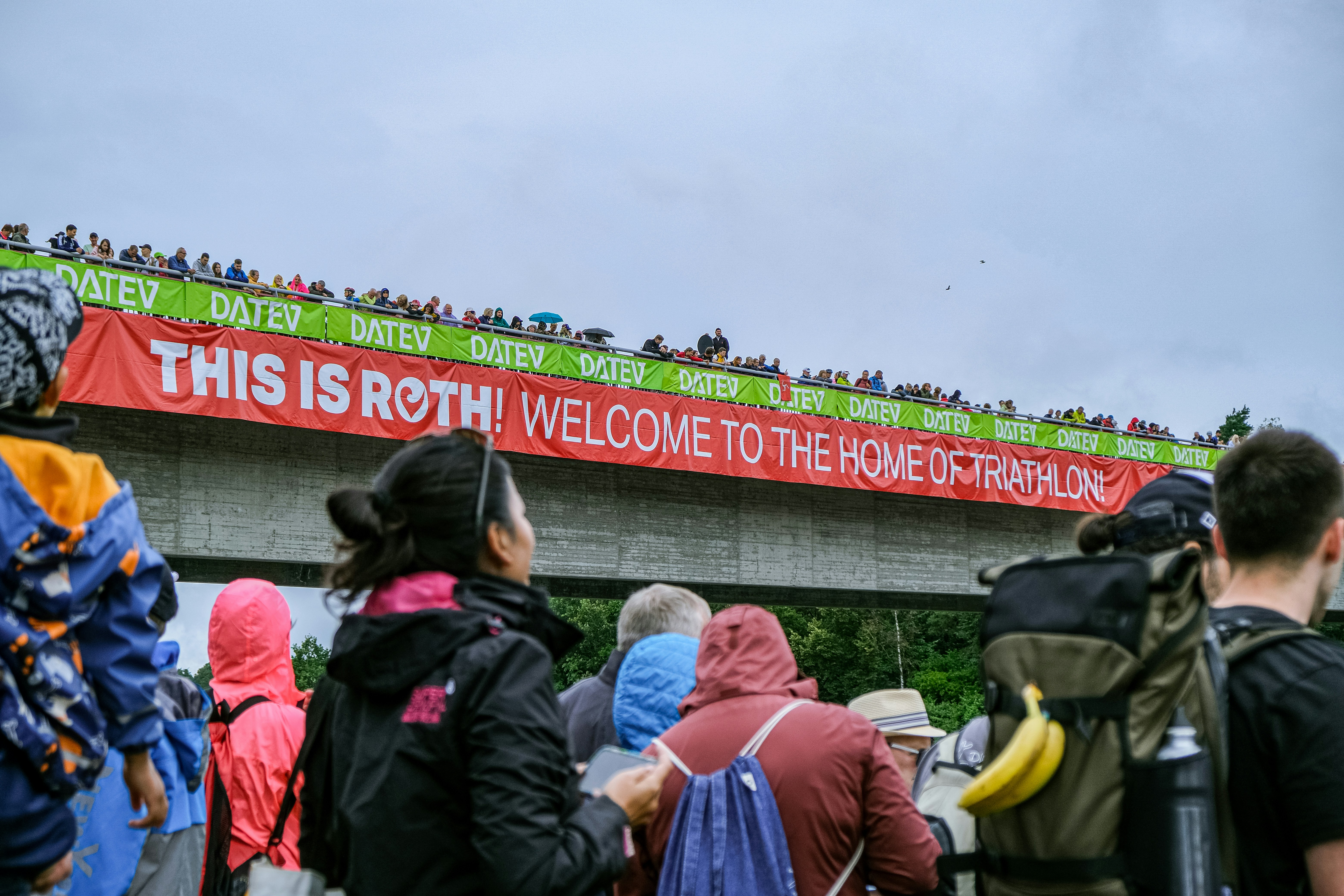 A group of people standing on top of a bridge