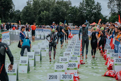 A group of people in wetsuits standing in the water