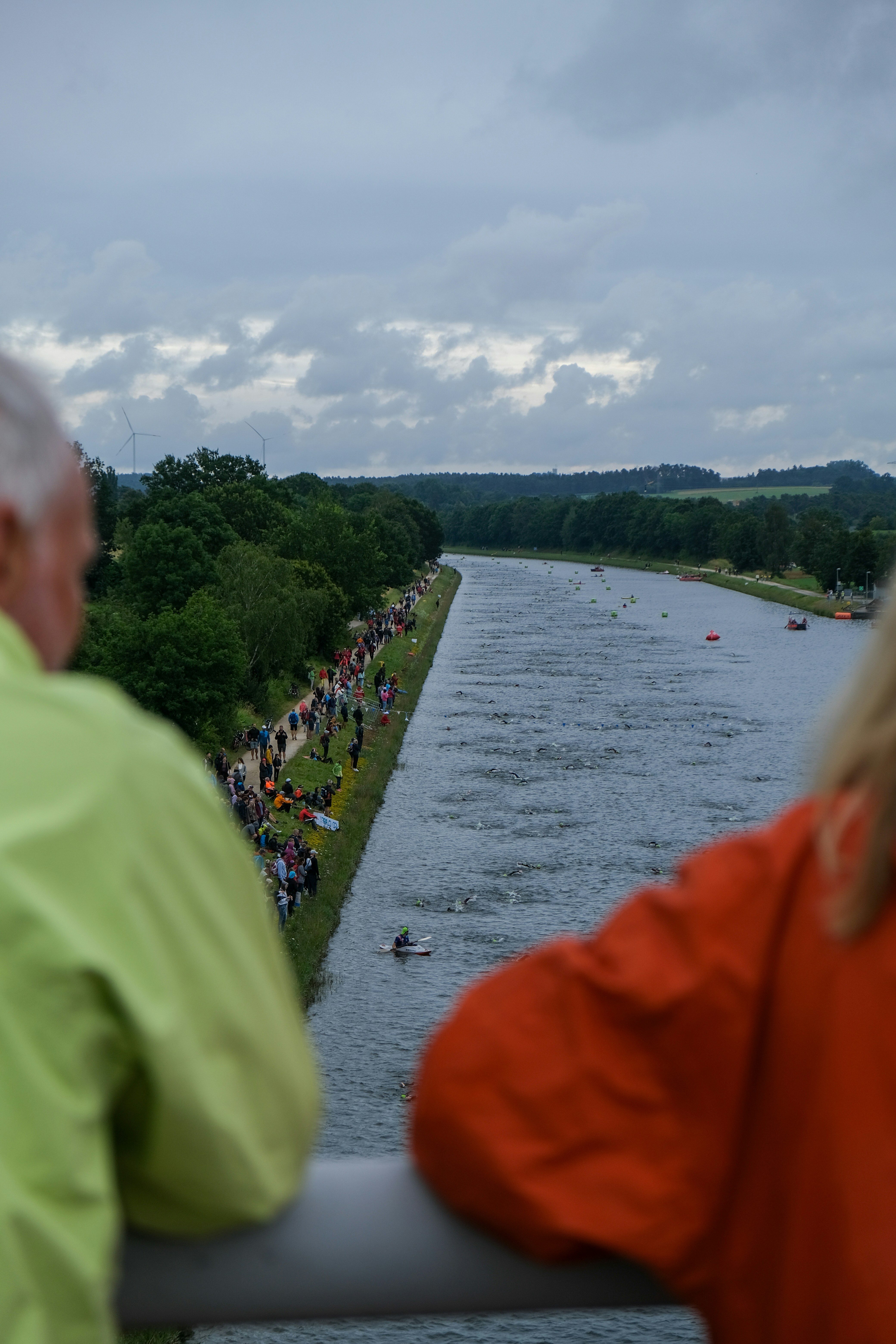 A couple of people that are looking at a river