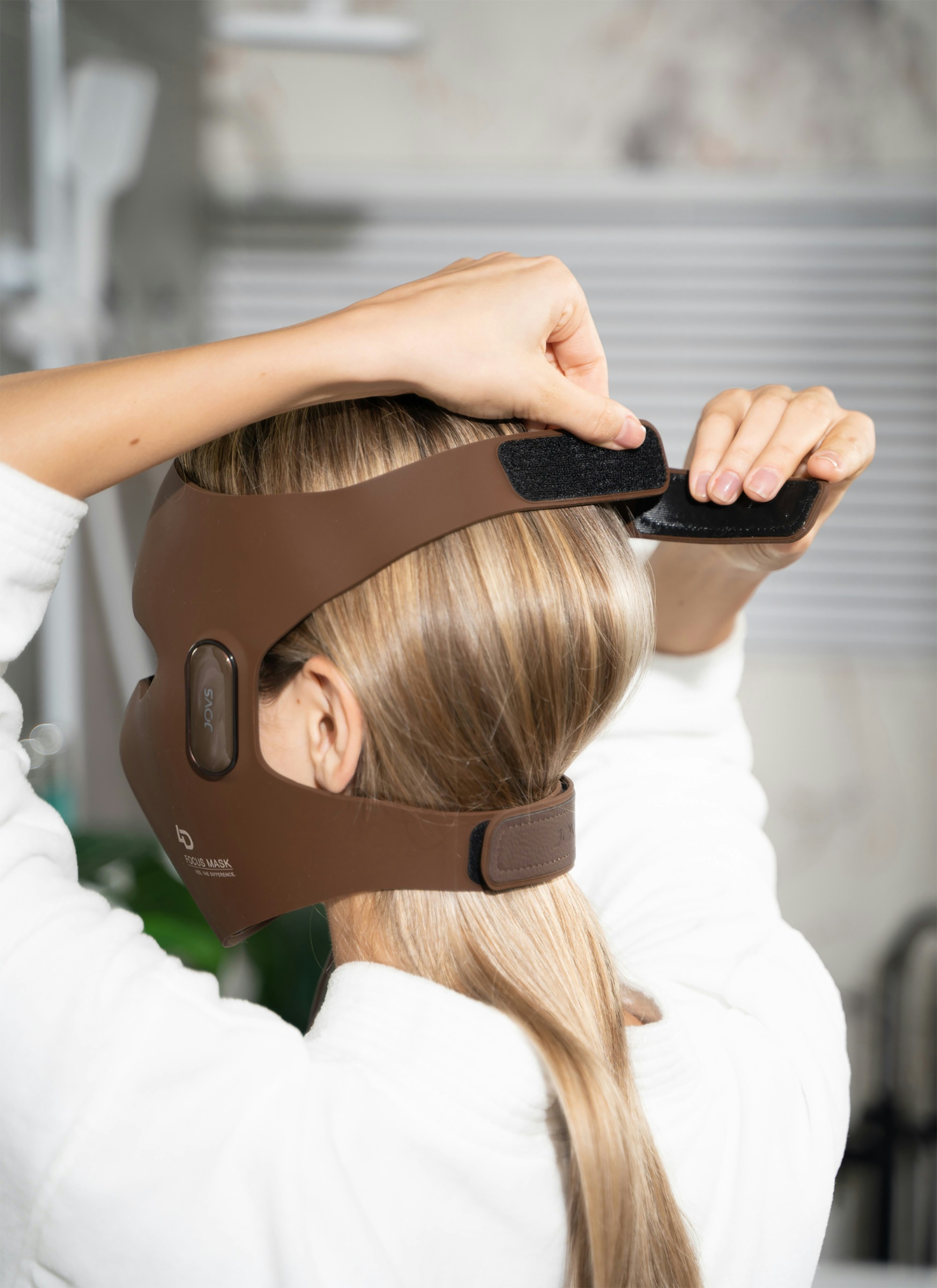 A woman in a white shirt wearing a brown headgear