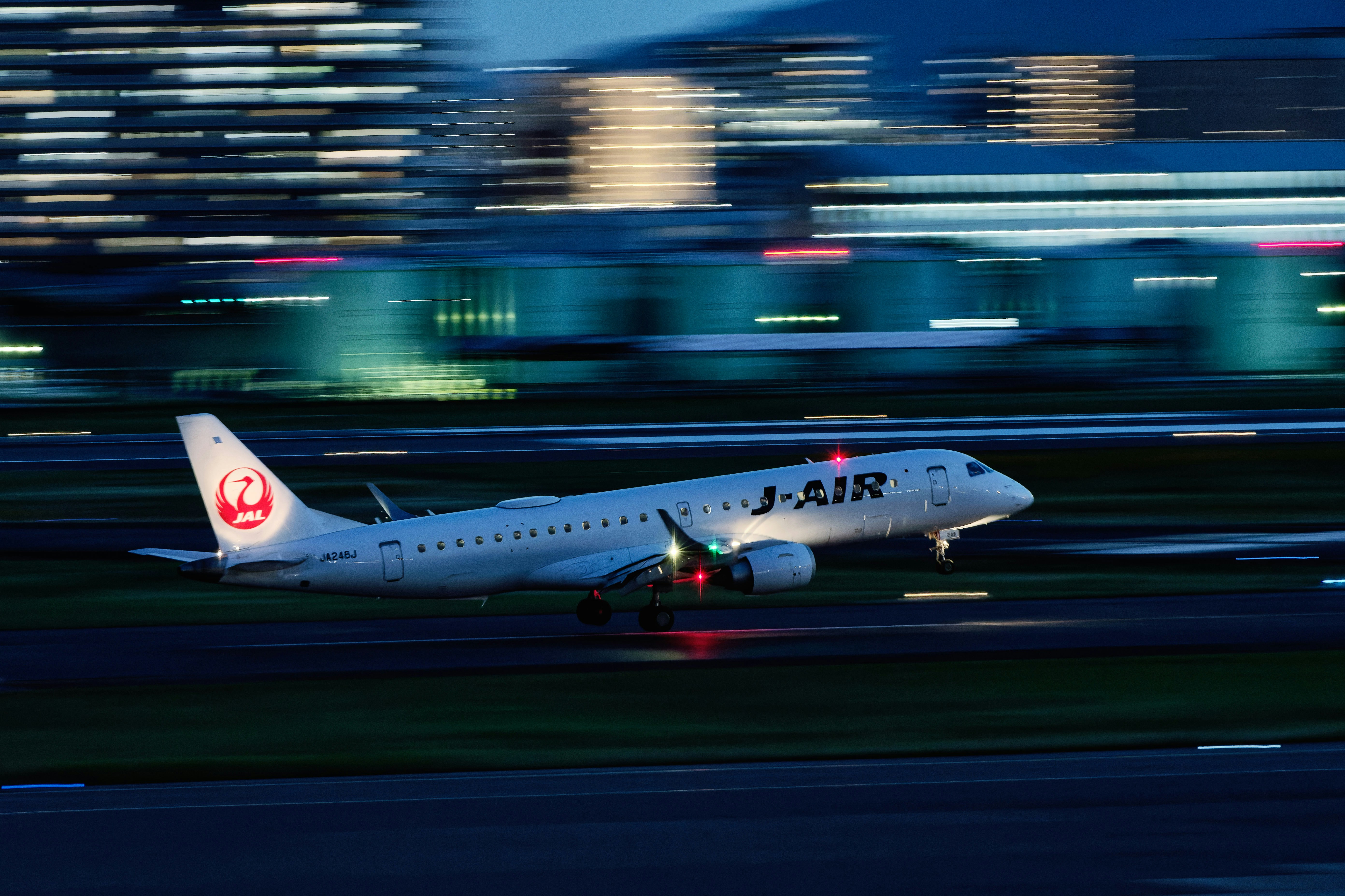A large passenger jet taking off from an airport runway, 