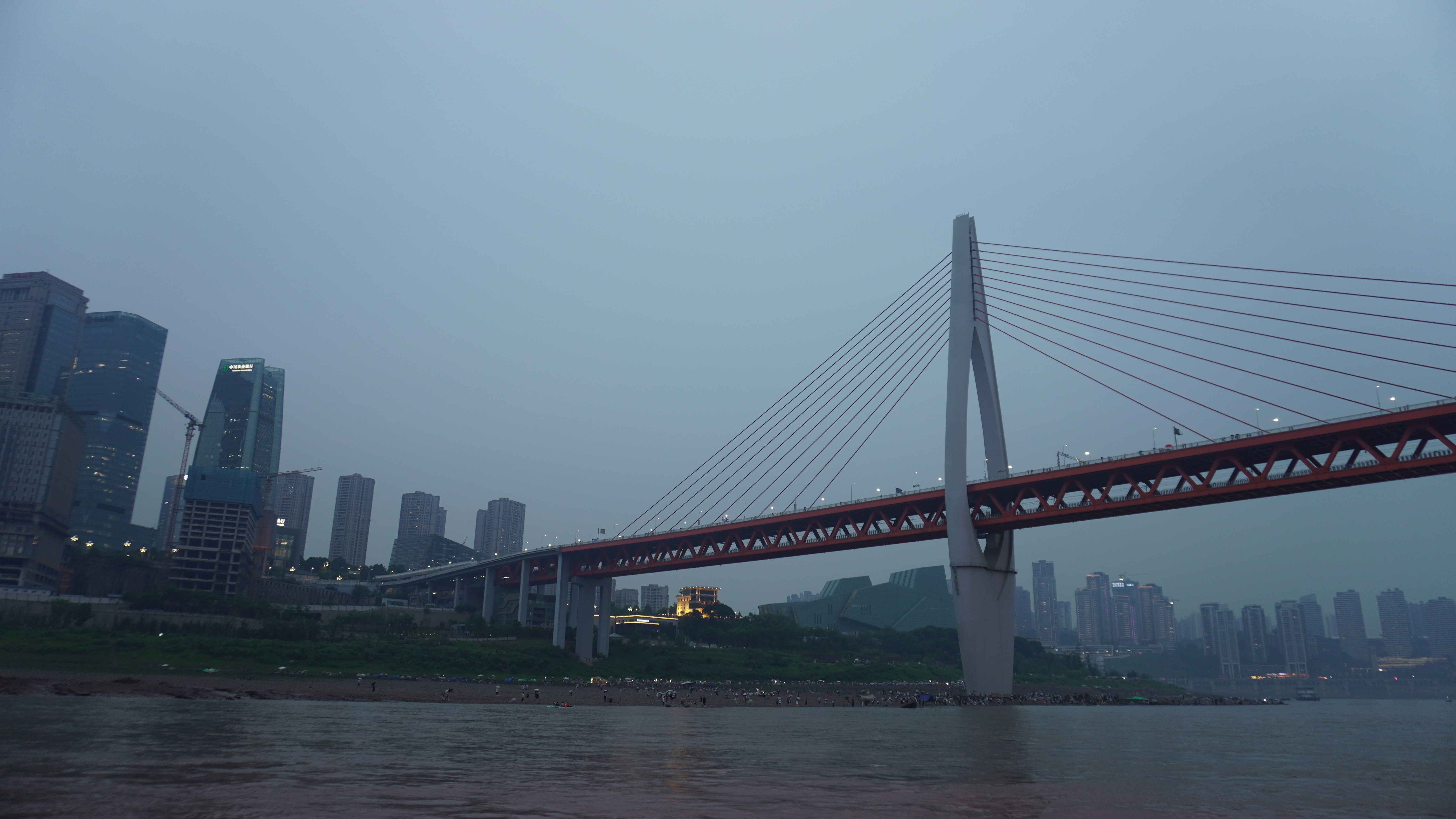 A view of a bridge with a city in the background