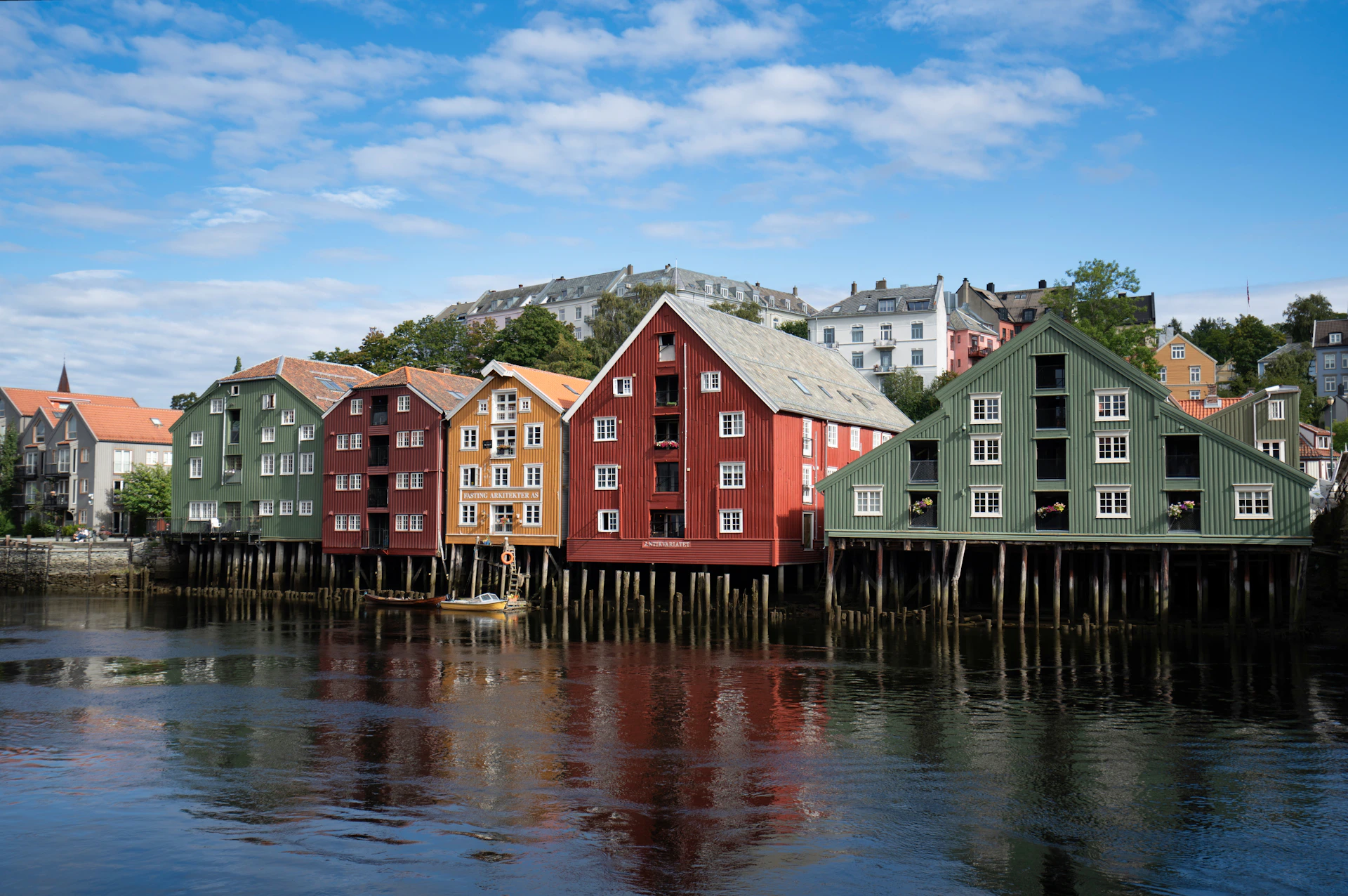 A row of houses sitting on the side of a body of water