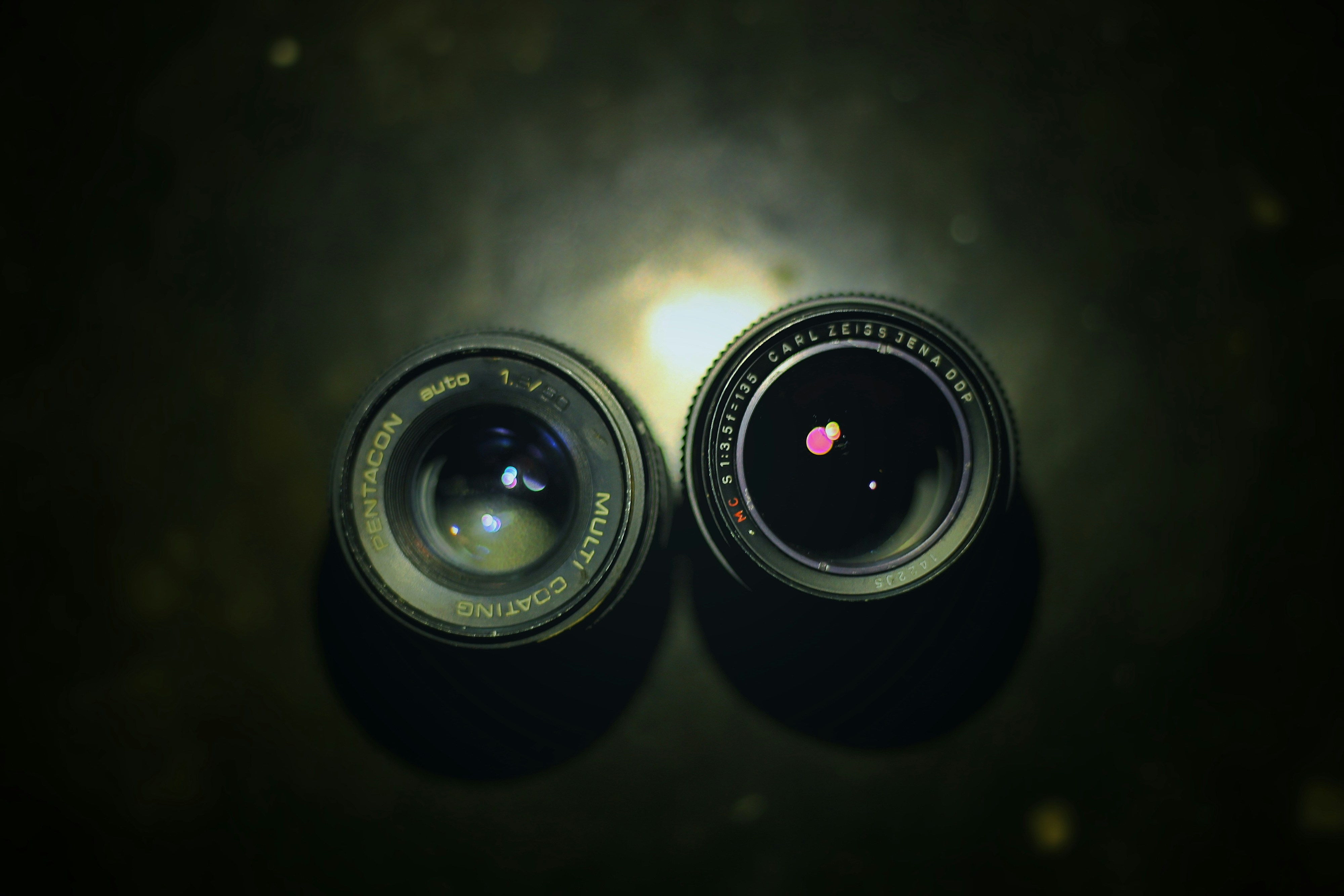A pair of camera lens sitting on top of a table