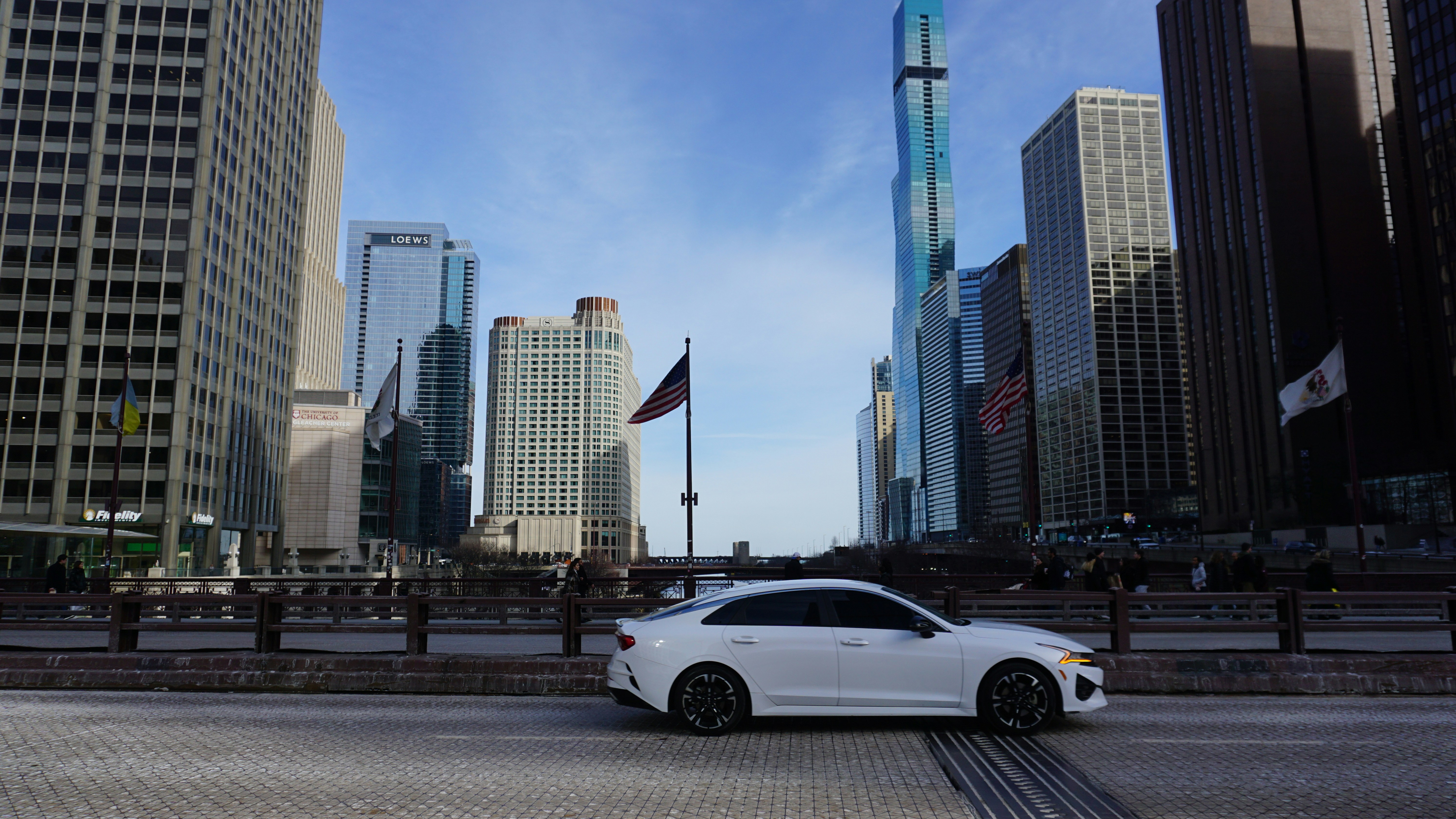 A modern hybrid car driving through a city, representing efficient urban commuting