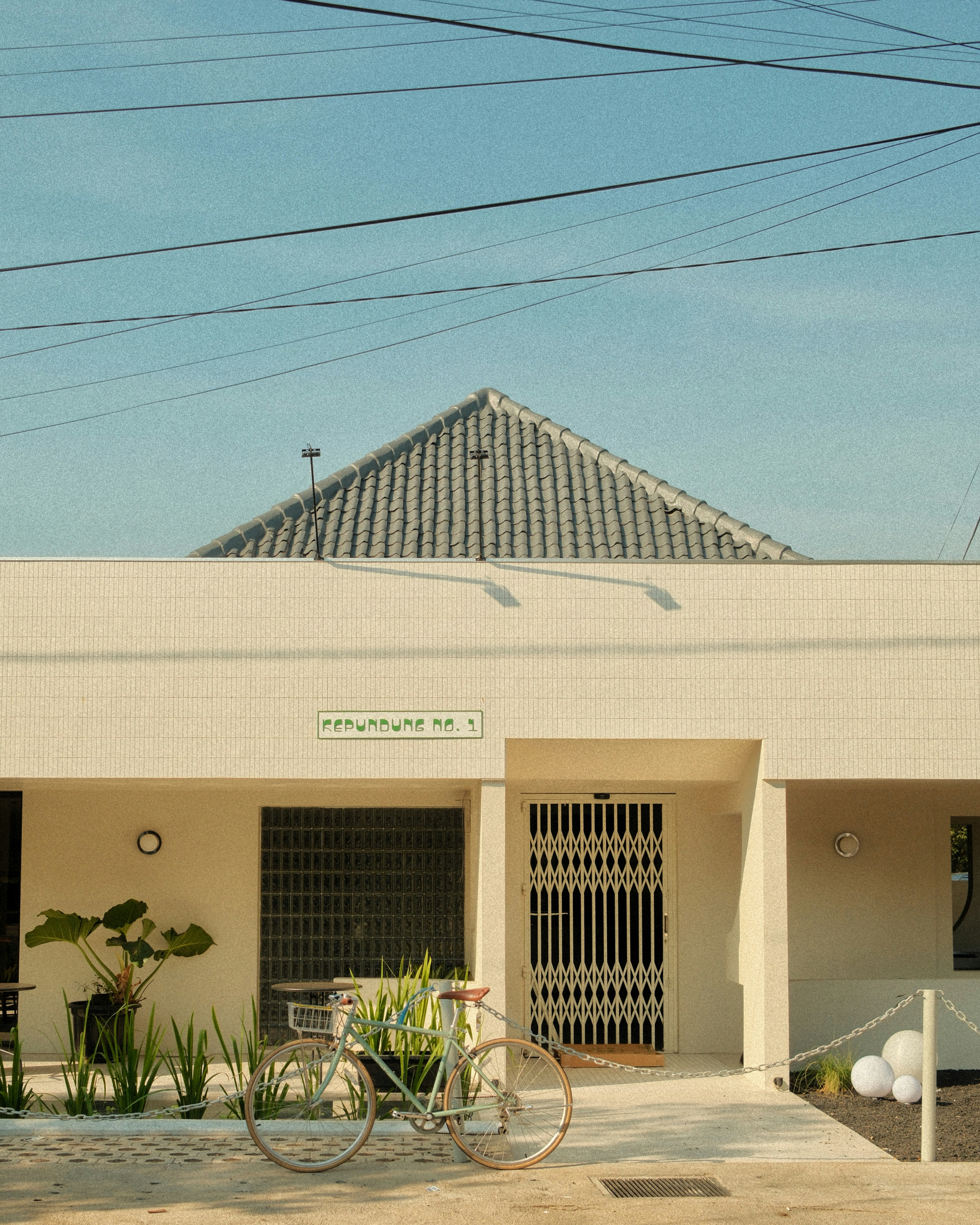 A white building with a bicycle parked in front of it