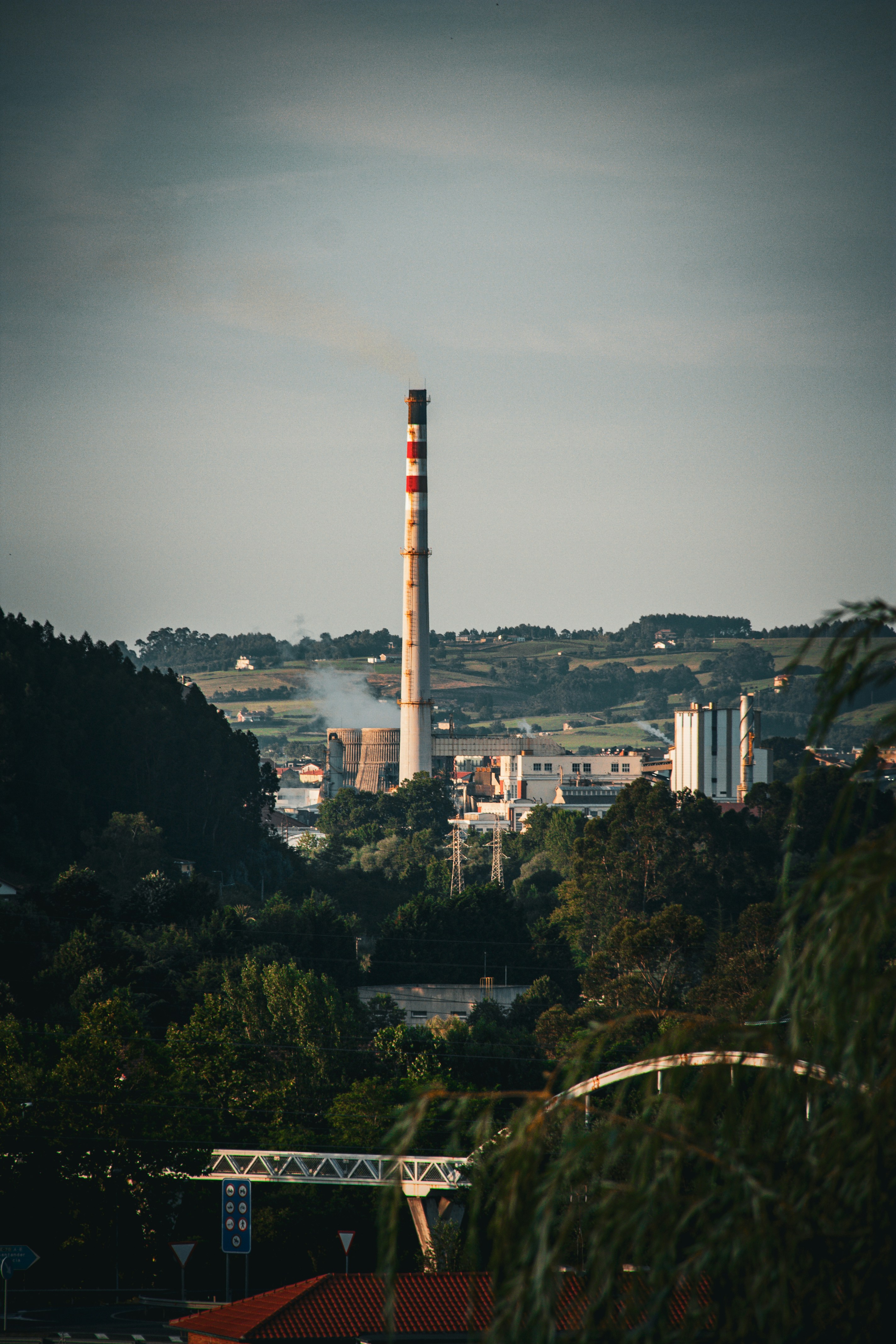 A factory with a smoke stack in the distance