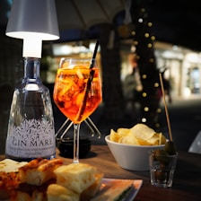 A table topped with a plate of food and a glass of wine