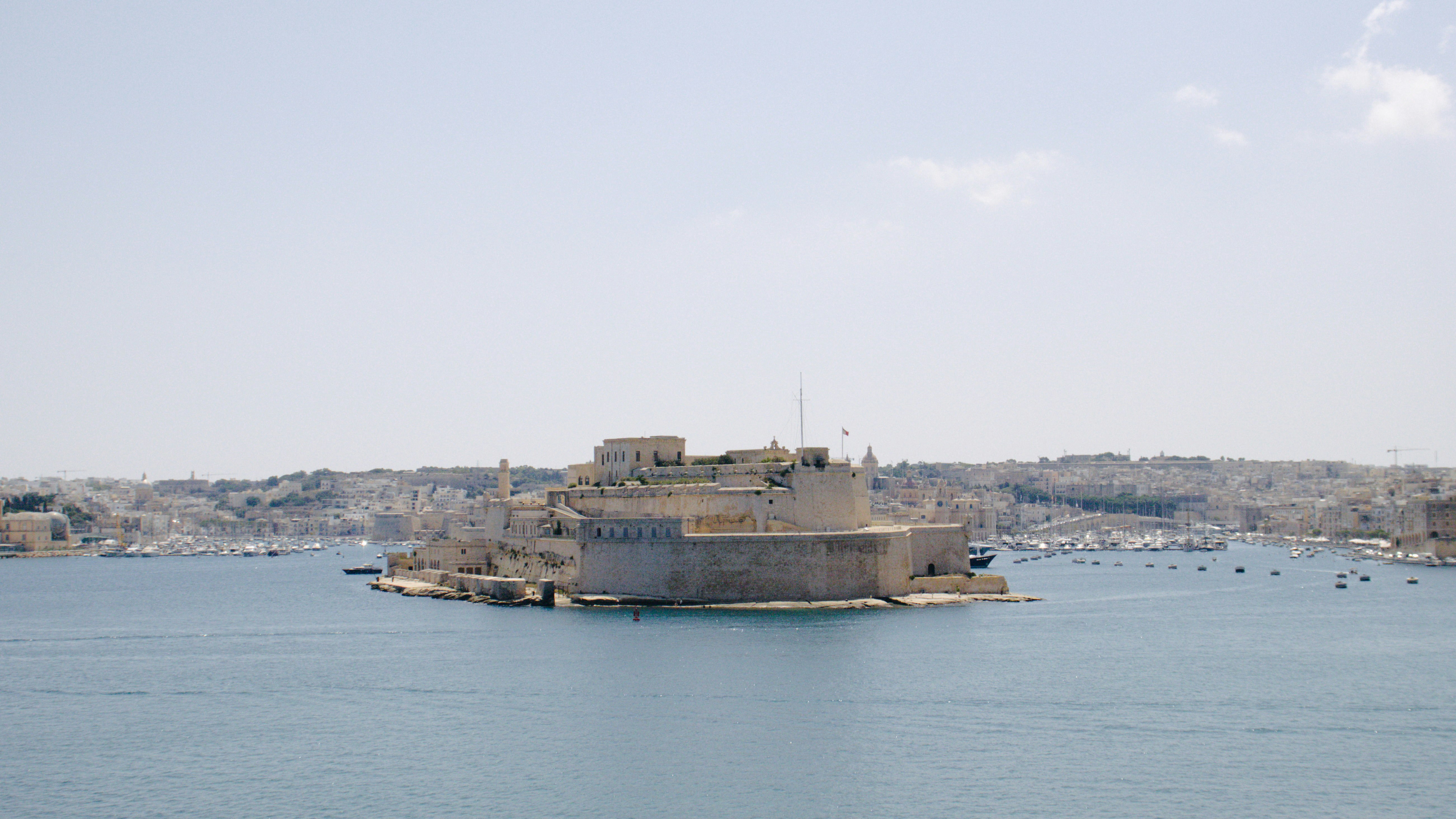 A large body of water with a city in the background