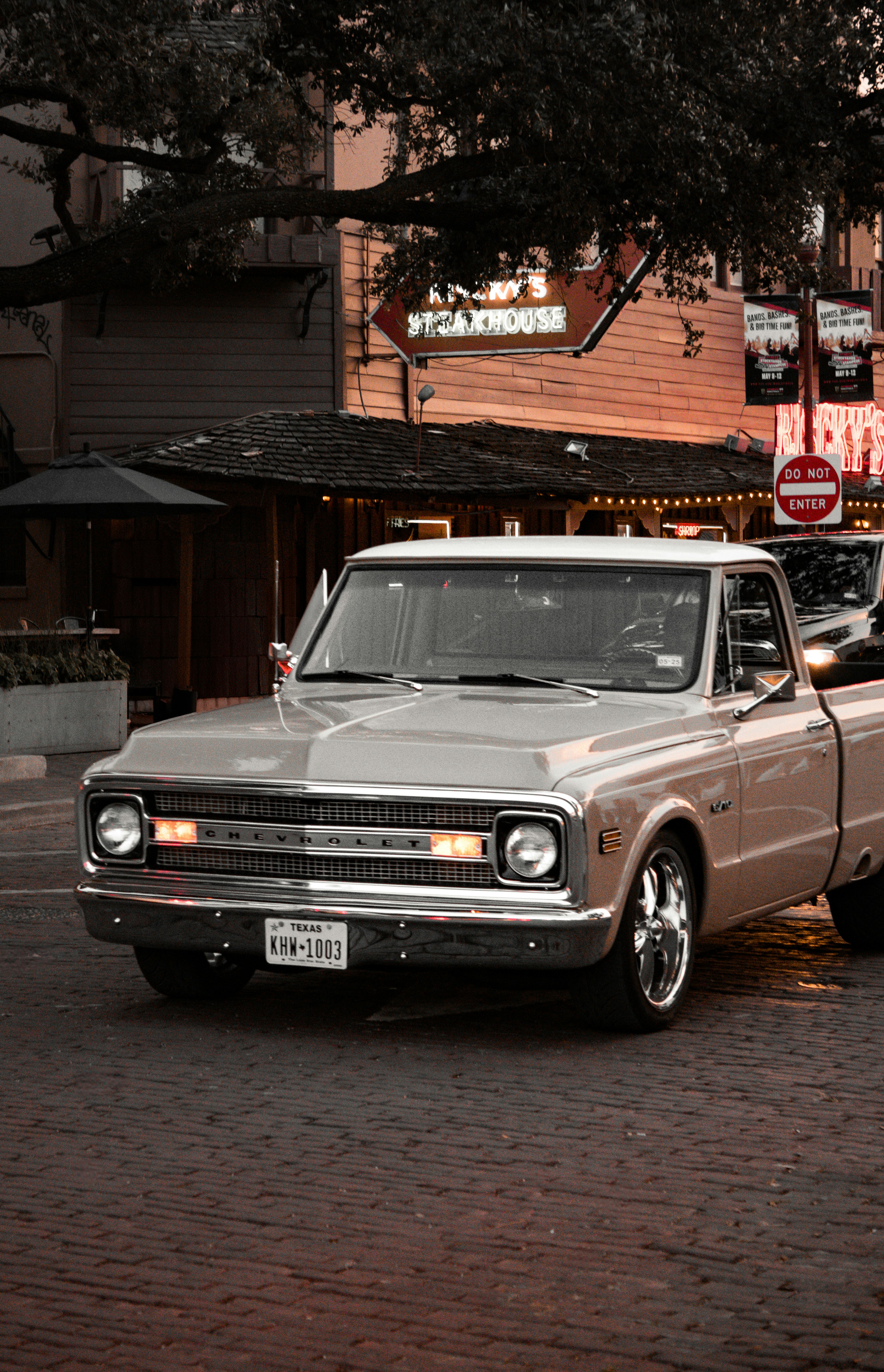 A silver truck parked on the side of a road