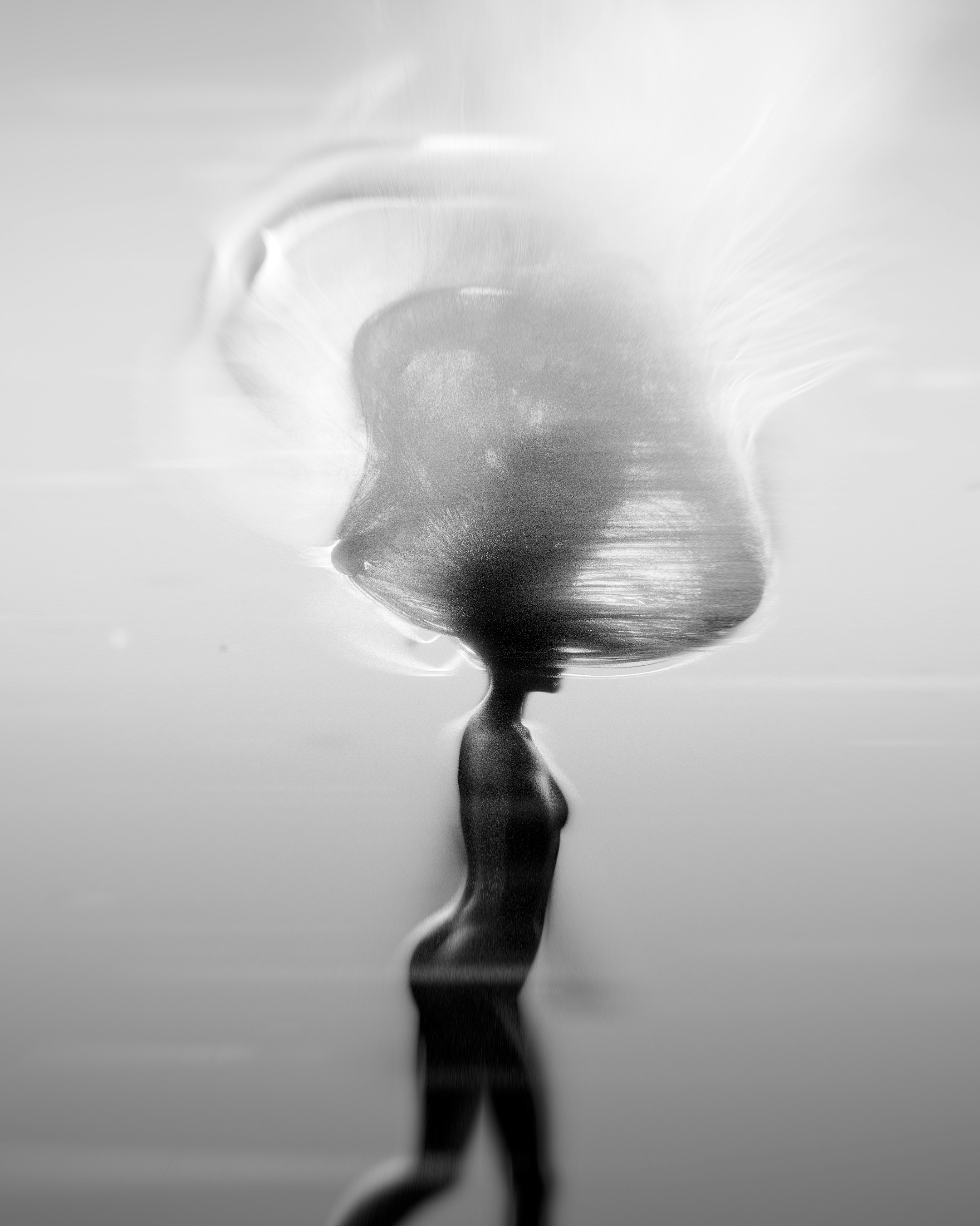 A blurry image of a person walking on a beach