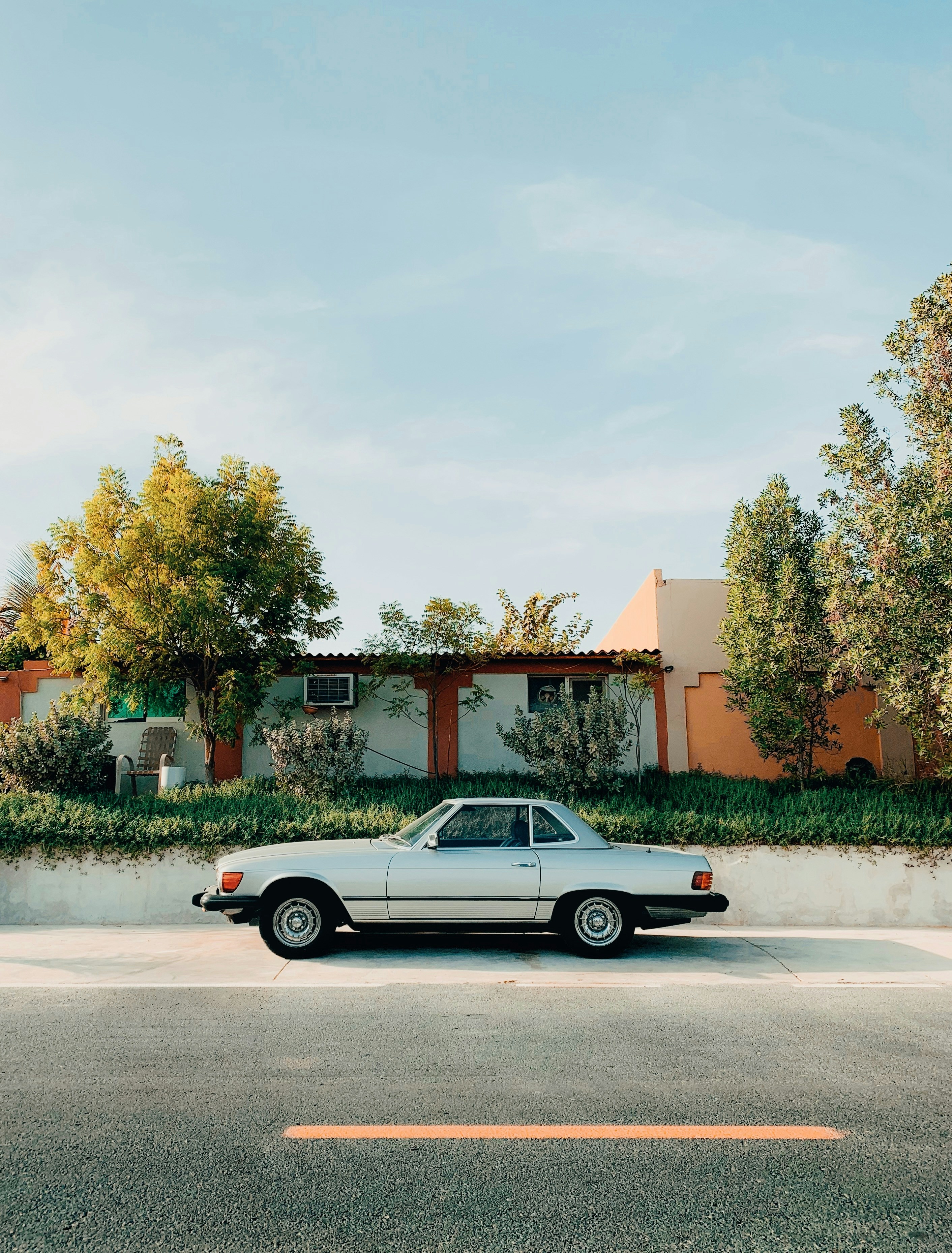 A white car parked in front of a house photo – Free Car Image on Unsplash