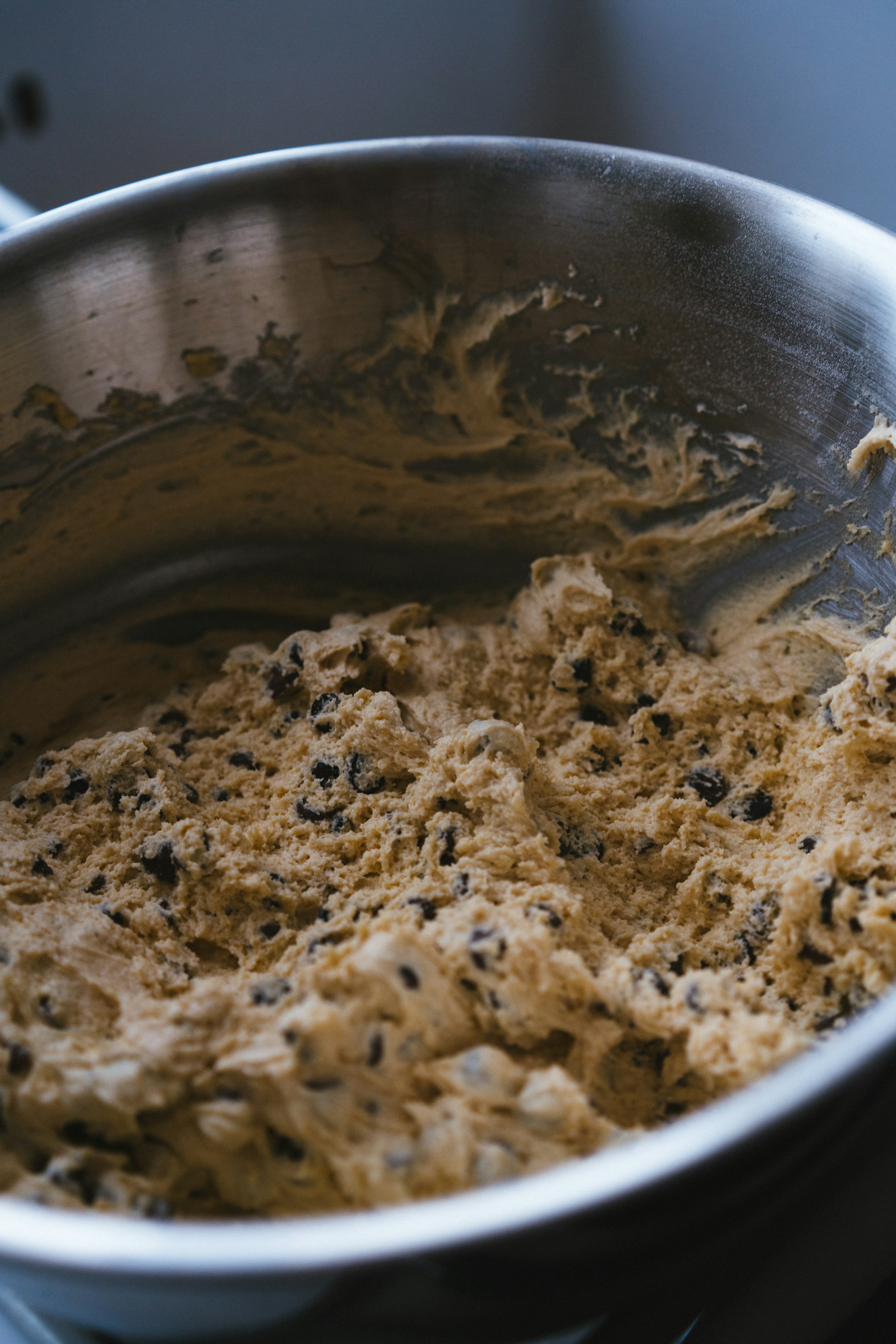 A metal bowl filled with batter on top of a stove