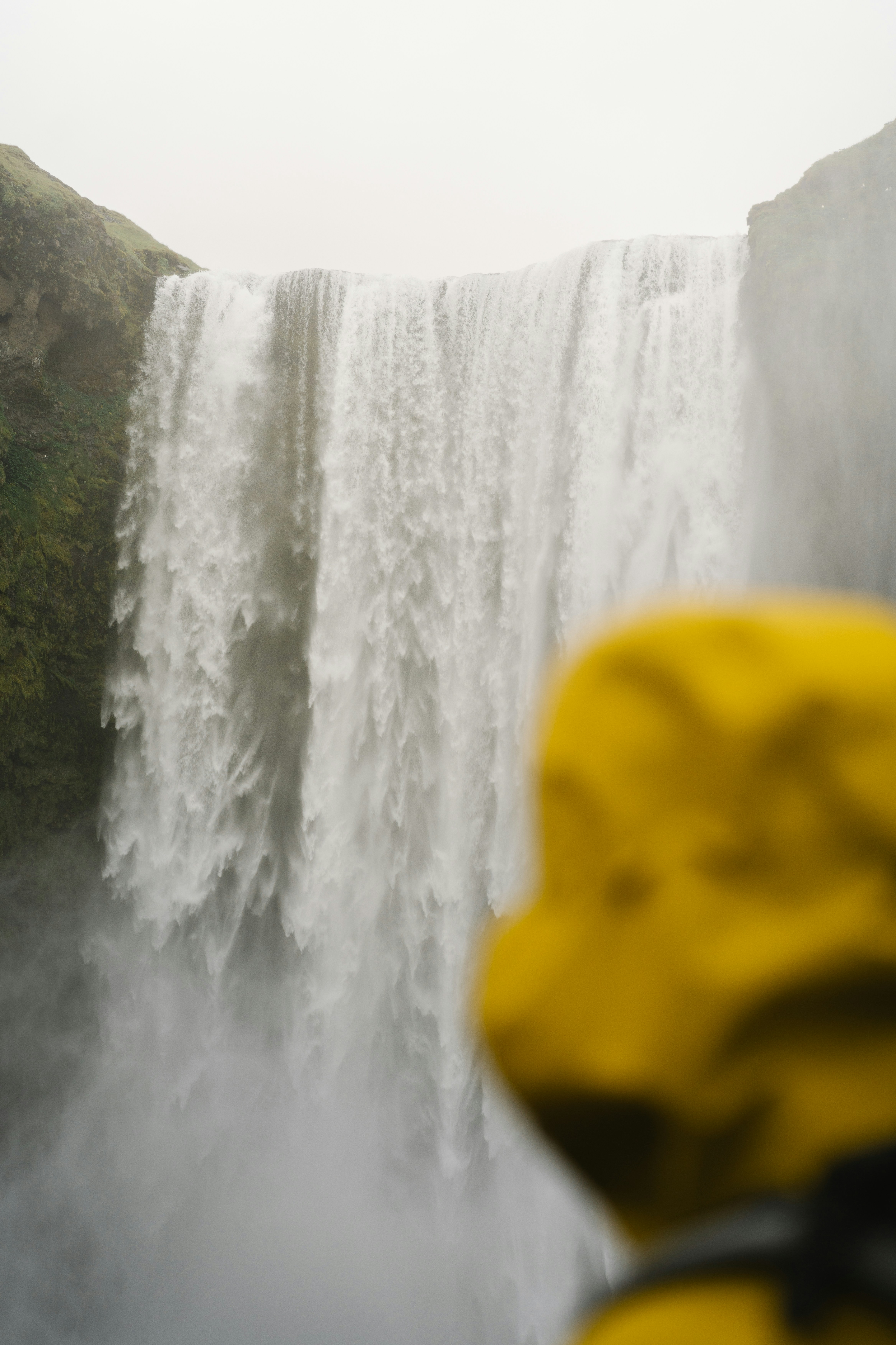 A person taking a picture of a waterfall