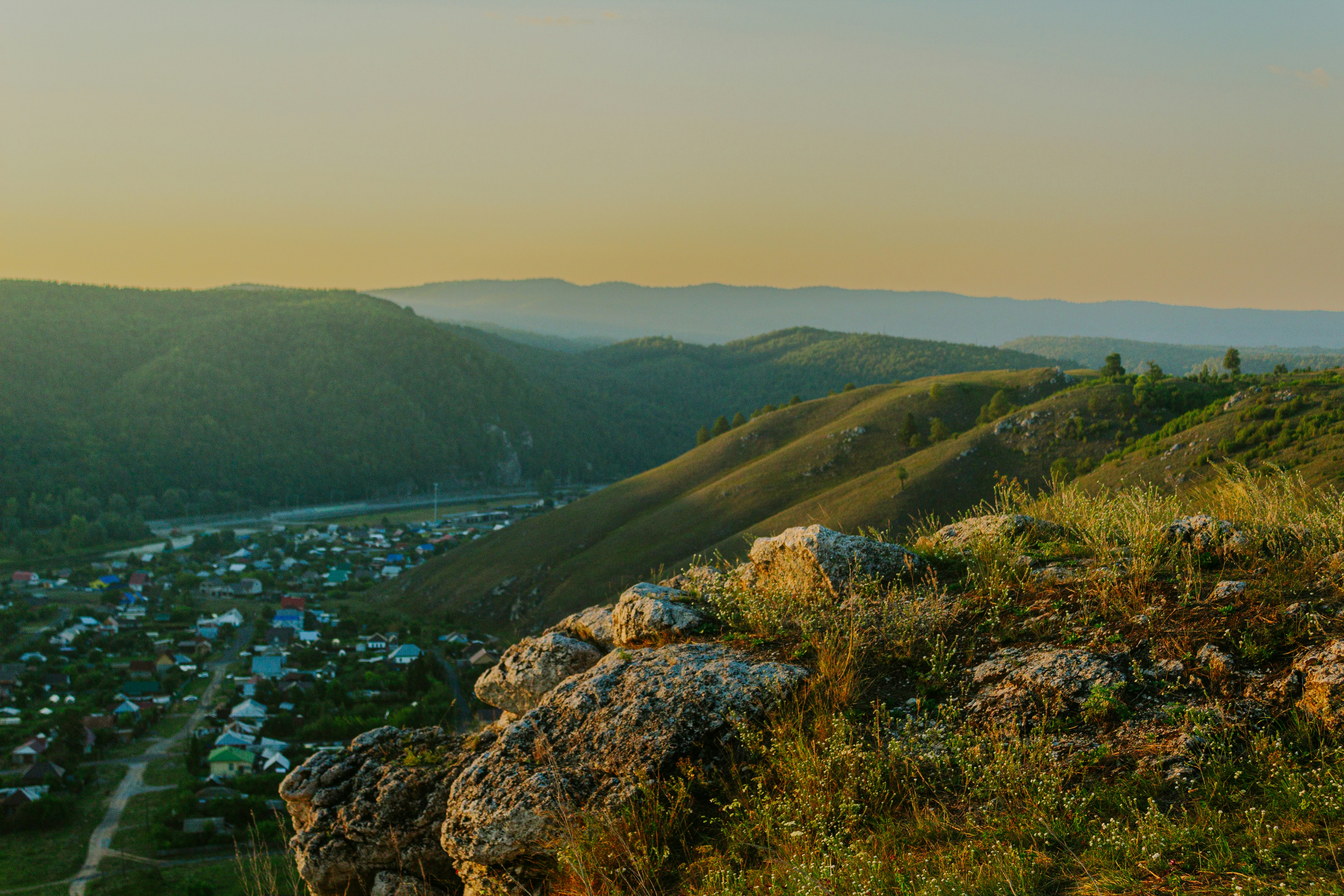 A person standing on a hill overlooking a valley