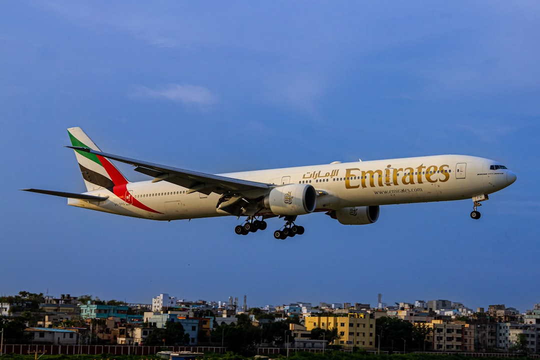 A large jetliner flying through a blue sky, Emirates Boeing 777-300 😍