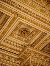 The ceiling of a building has gold paint on it