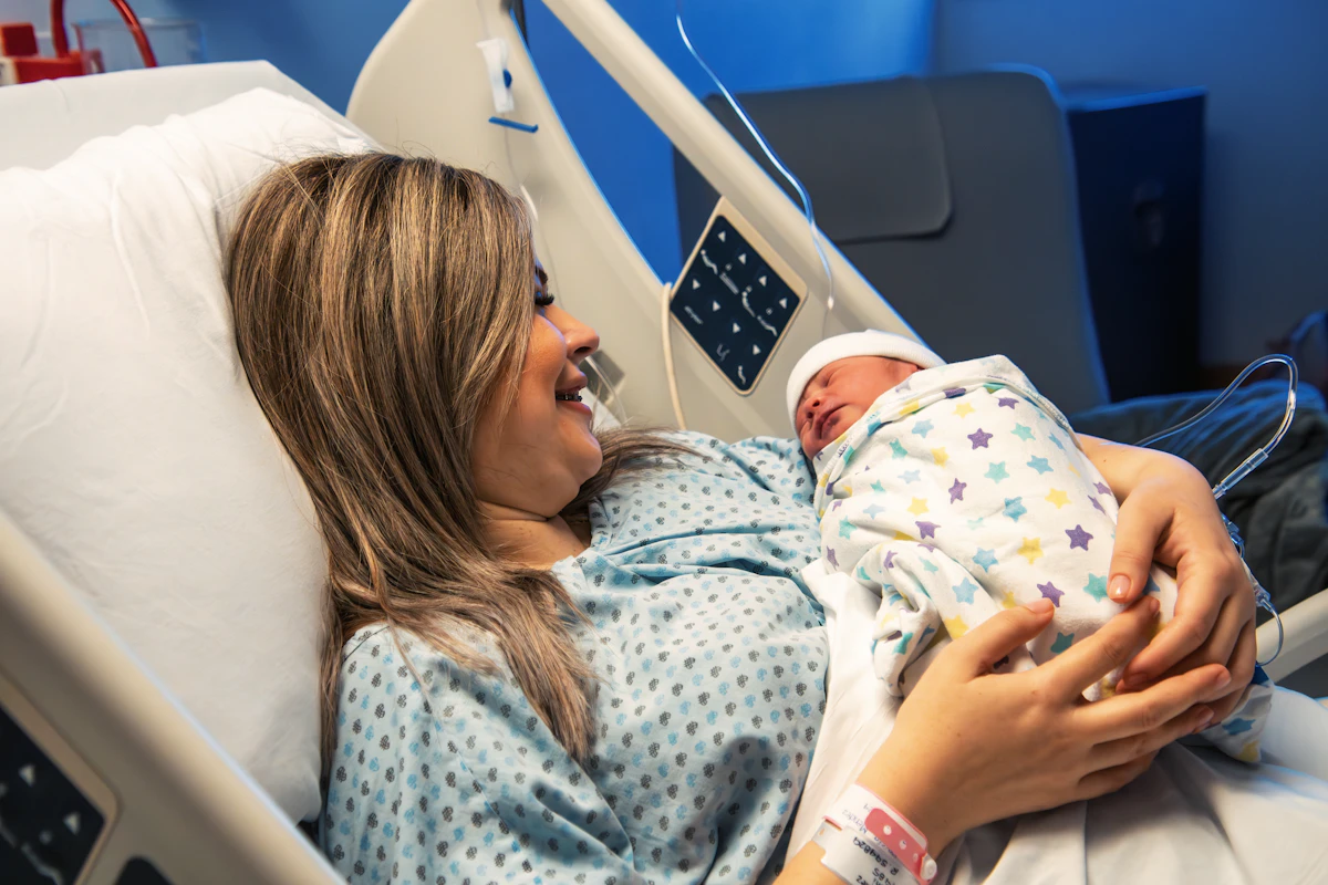 Mother holding her baby in a hospital bed