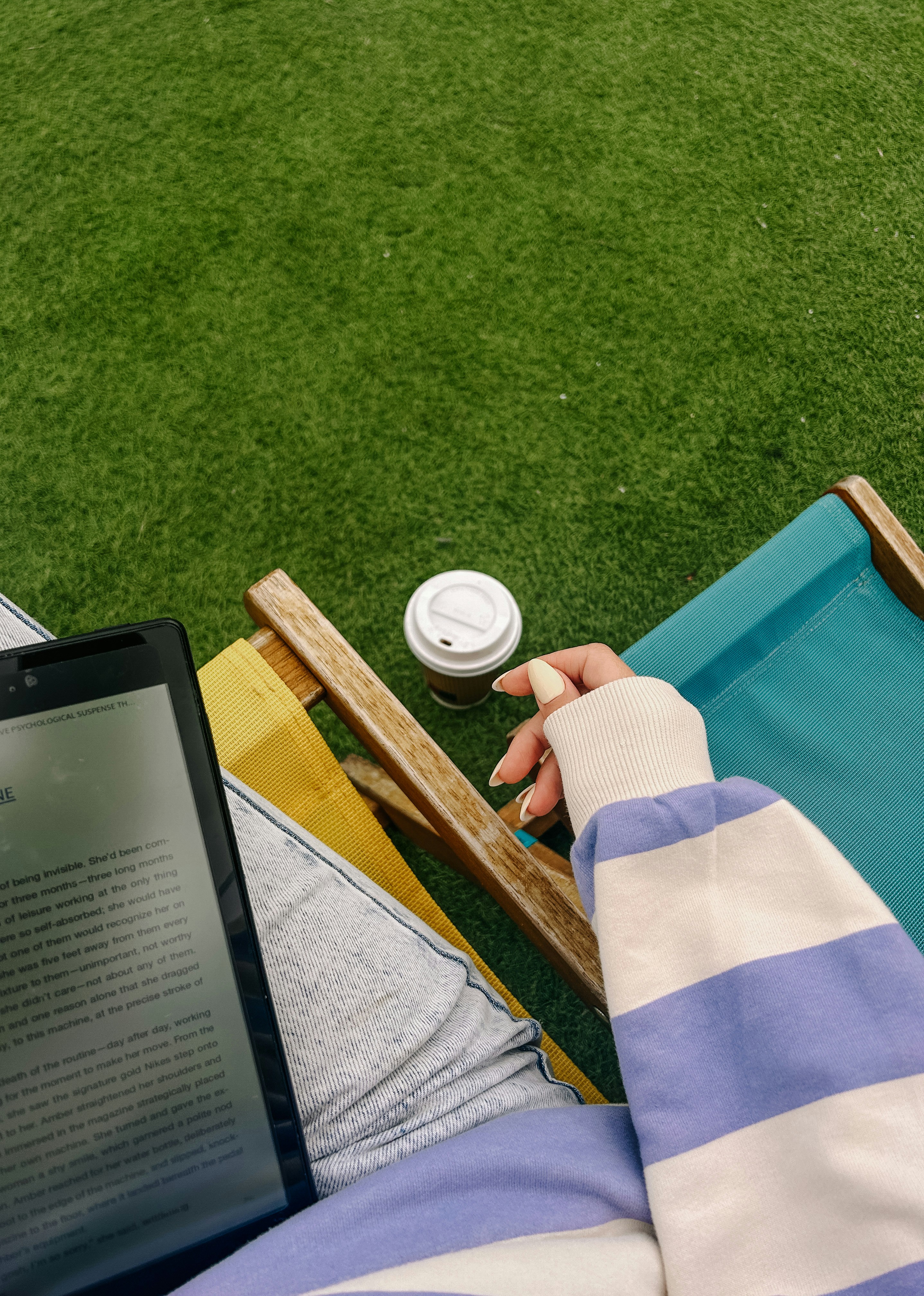 A person sitting in a lawn chair using a laptop
