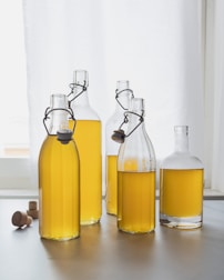 A group of bottles filled with yellow liquid