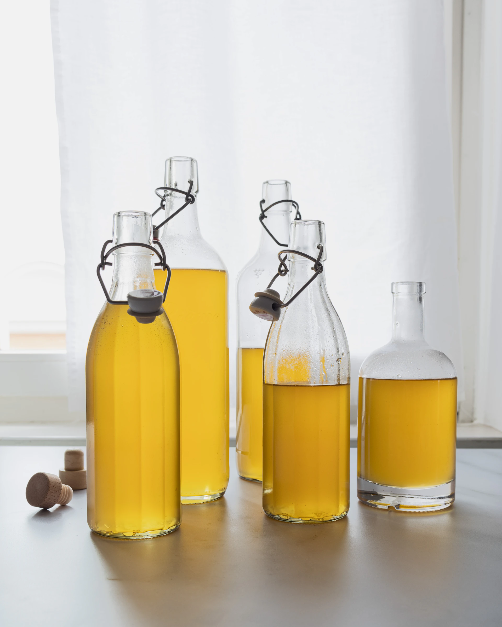 A group of bottles filled with yellow liquid