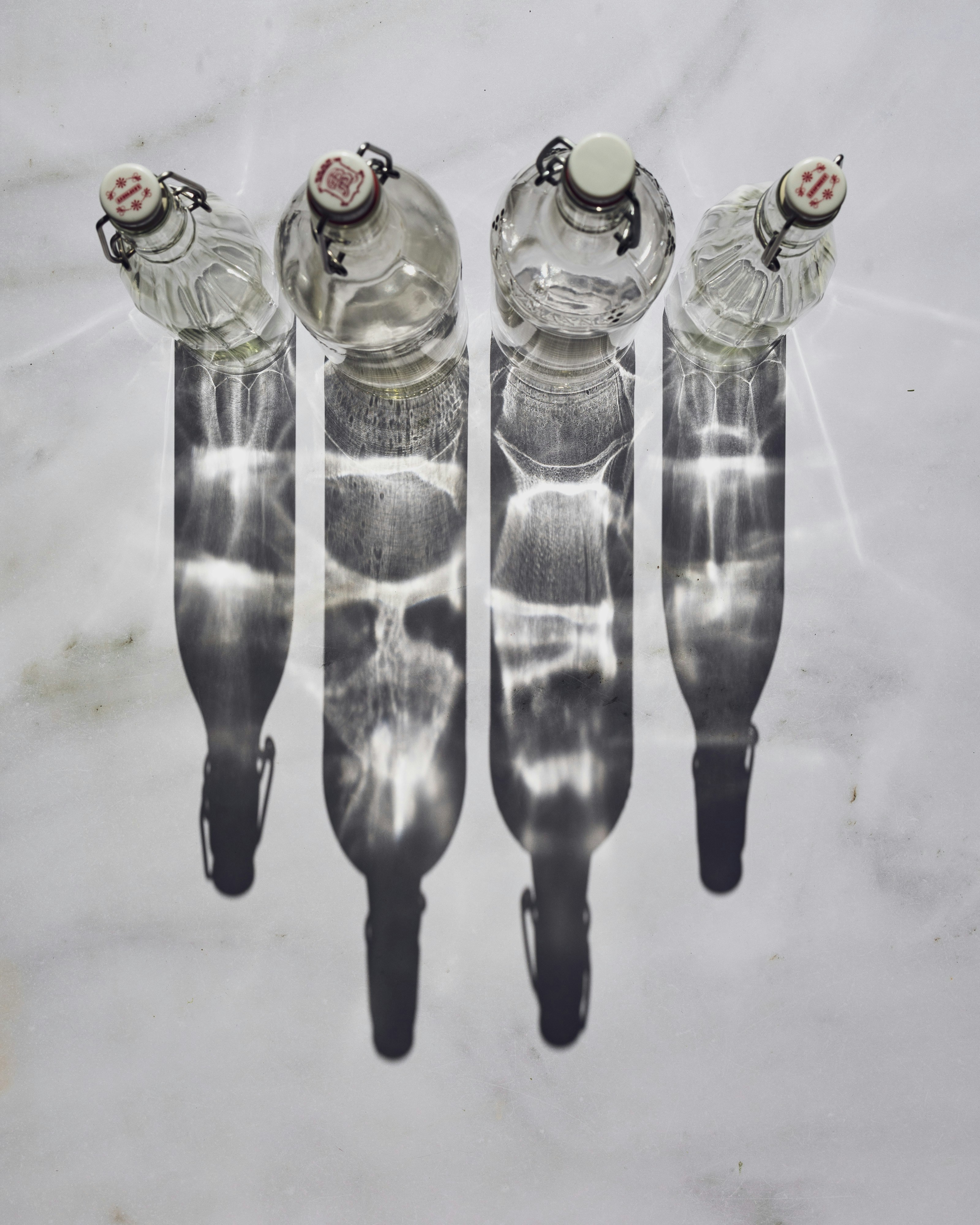 A group of four water bottles sitting on top of a table
