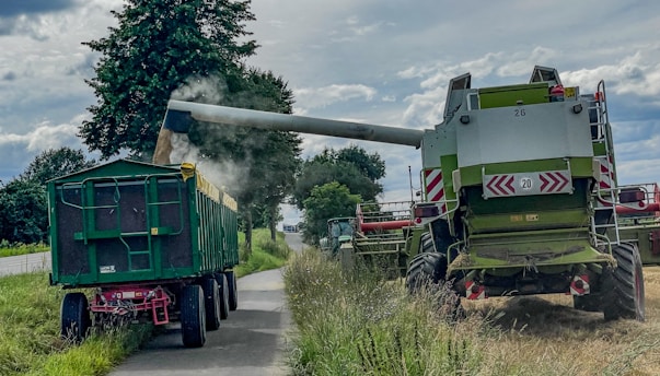 A couple of large trucks driving down a road