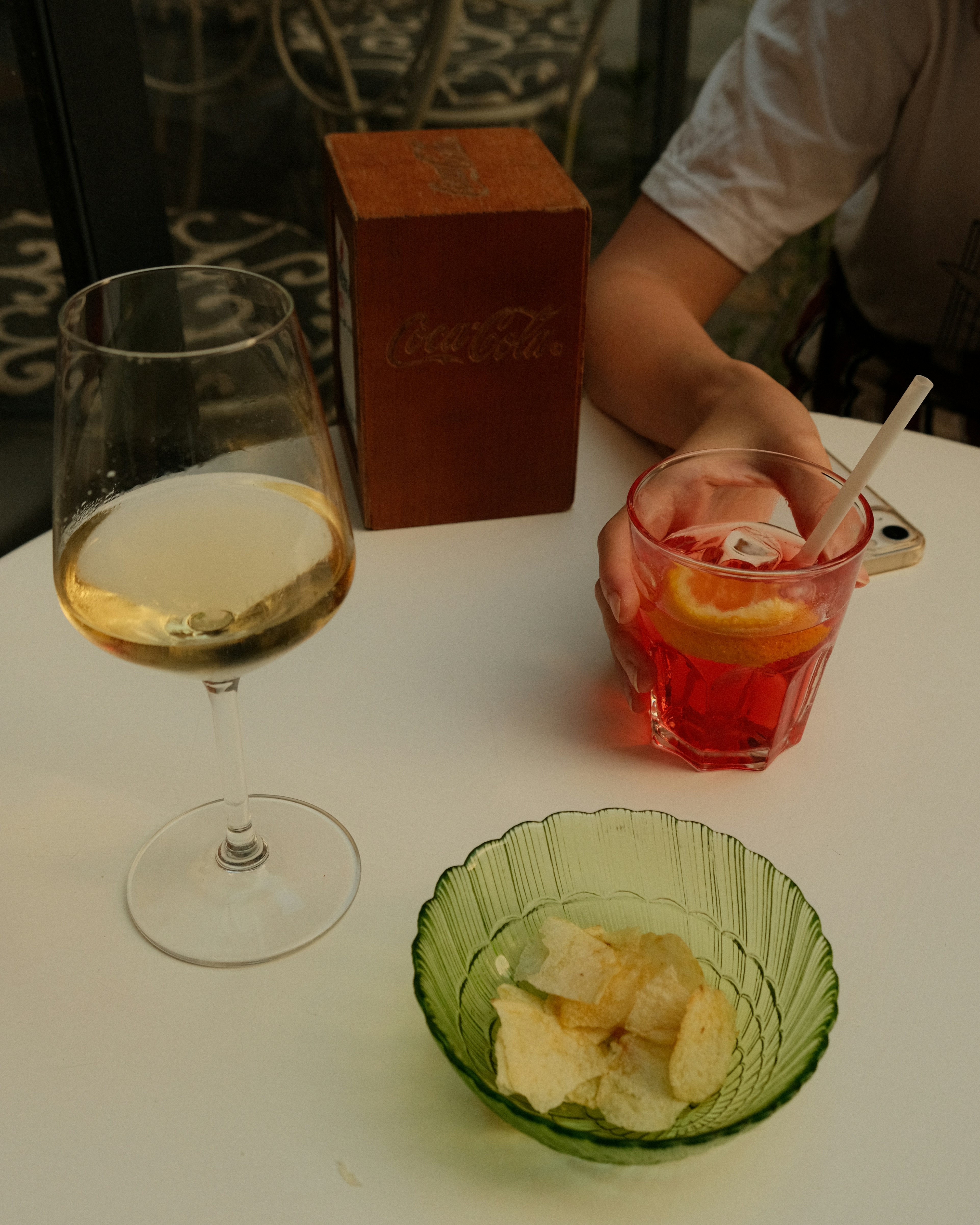 A person sitting at a table with two glasses of wine