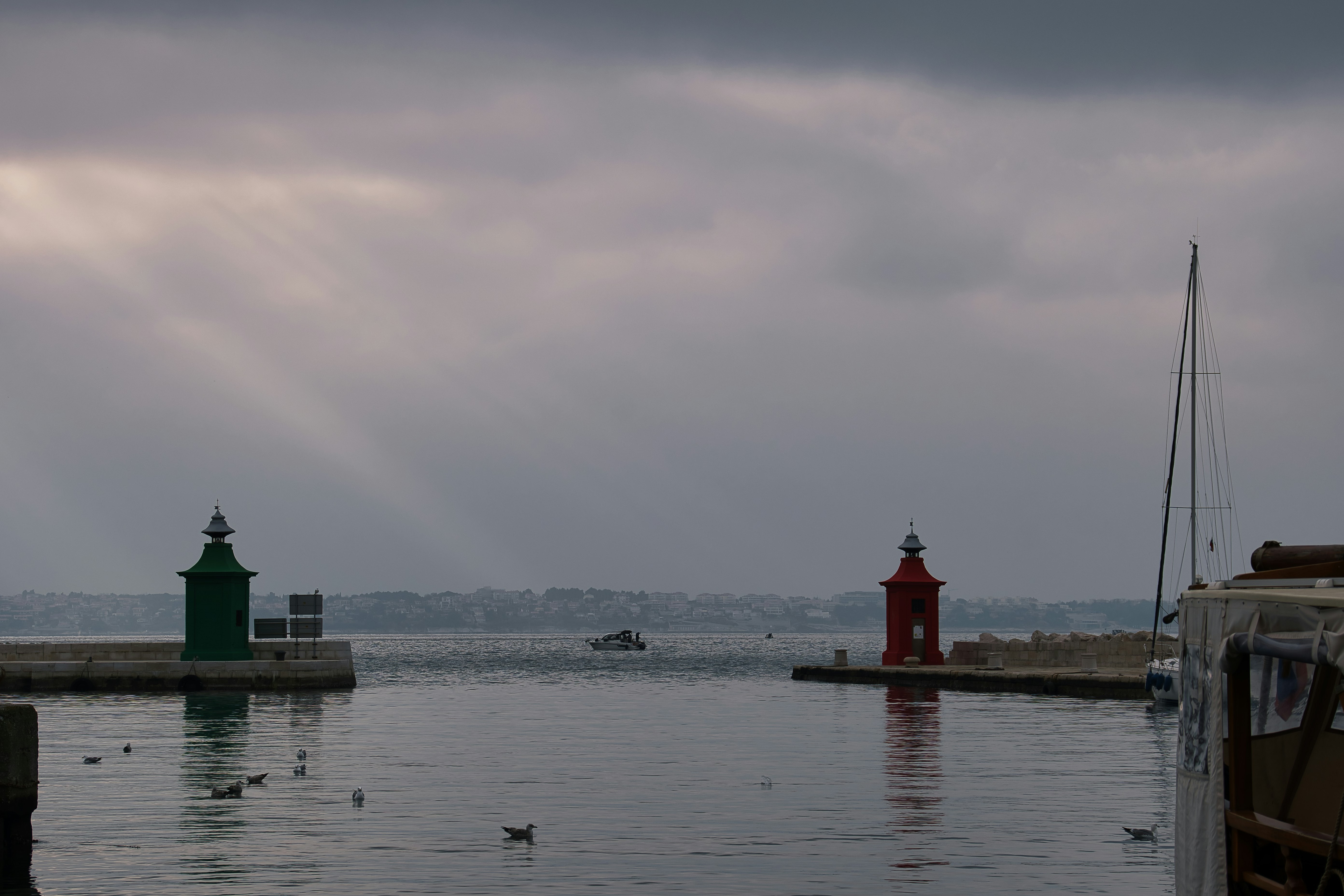 A body of water with a lighthouse in the distance